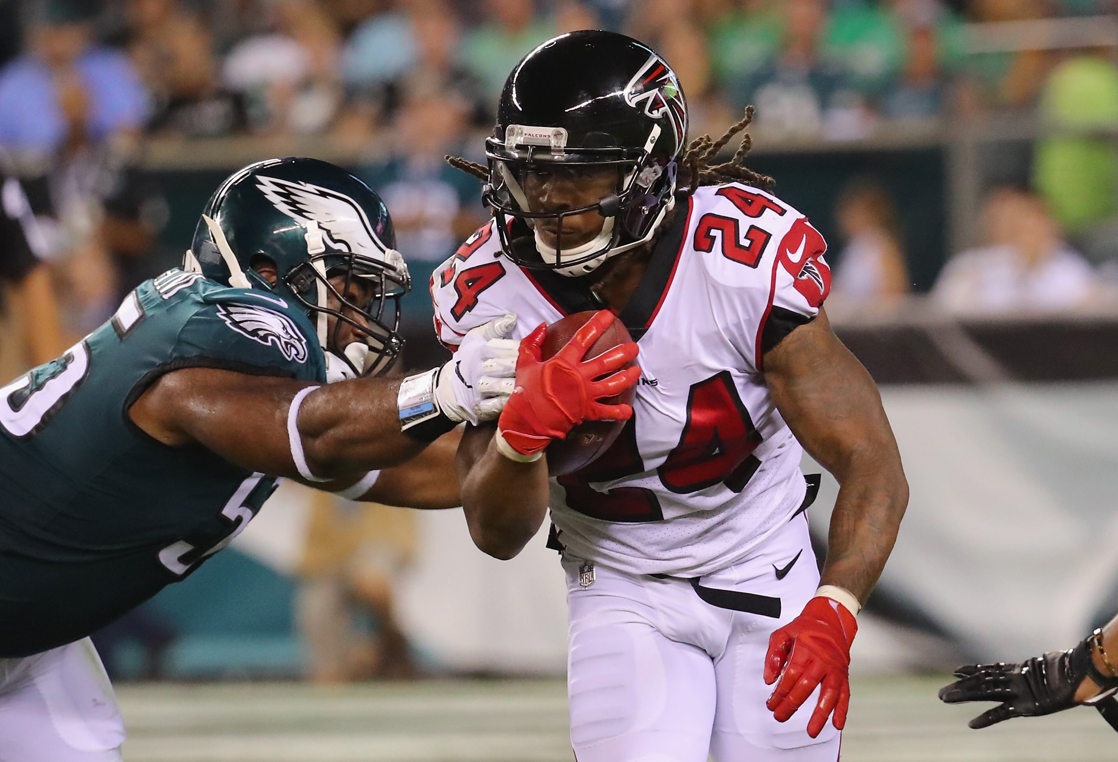 PHILADELPHIA, PA - SEPTEMBER 06: Devonta Freeman #24 of the Atlanta Falcons is tackled by Brandon Graham #55 of the Philadelphia Eagles during the first half at Lincoln Financial Field on September 6, 2018 in Philadelphia, Pennsylvania. (Photo by Brett Carlsen/Getty Images)