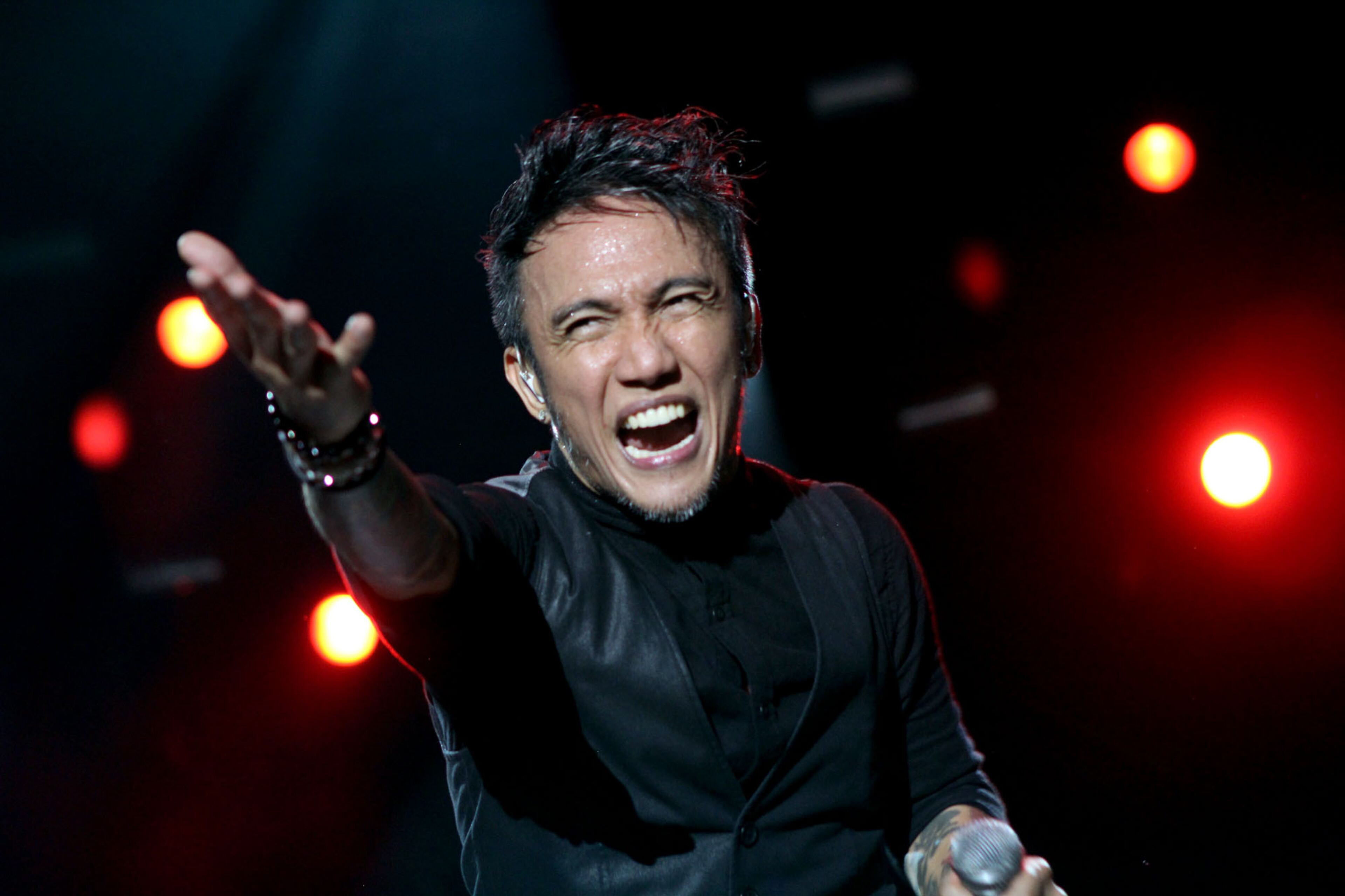 Arnel Pineda lead vocalist for Journey, exhorts the crowd to sing along with their classic hits such as "Any Way You Want It, " as they close out the first night of Music Midtown on Friday.
