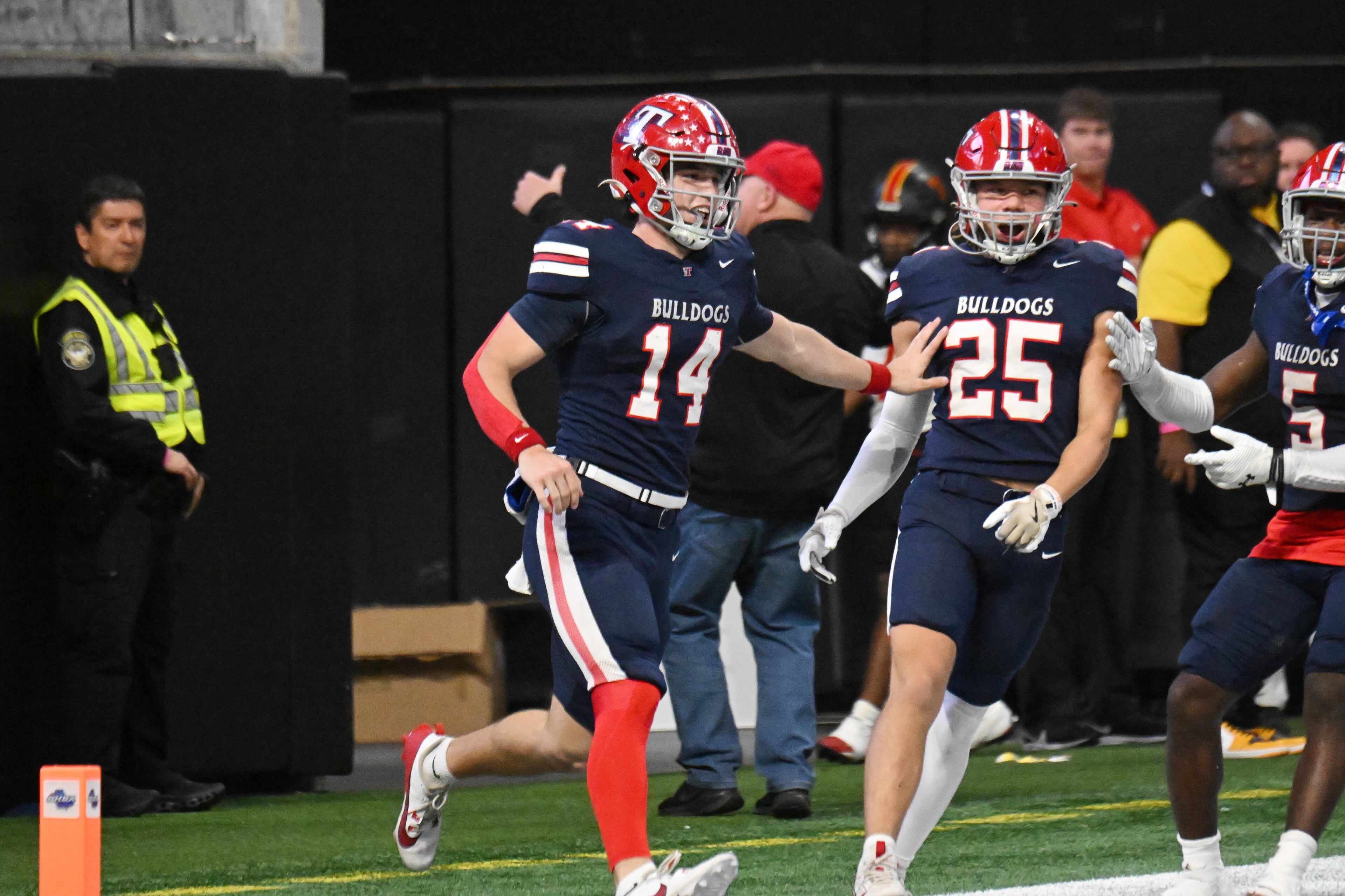Toombs County's quarterback Tj Stanley (14) celebrates after scoring a touchdown during the fourth quarter in GHSA Class A-Division State Championship game at Mercedes-Benz Stadium, Tuesday, December 17, 2024, in Atlanta. Toombs County won 38-18 over Northeast Macon. (Hyosub Shin / AJC)