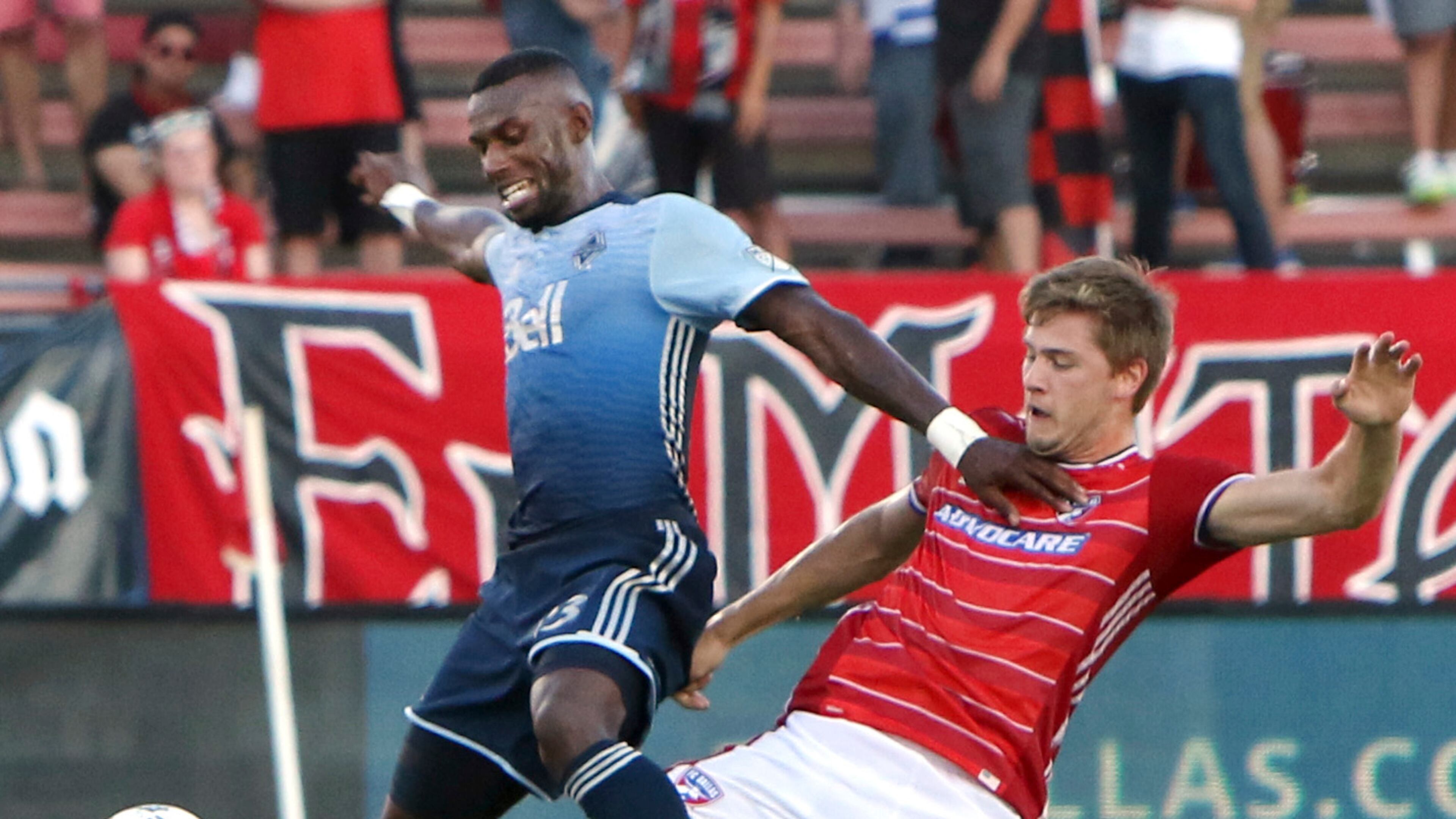FC Dallas' Walker Zimmerman (25) stretches to steal the ball from Vancouver Whitecaps' Bernie Ibini-lsei (23) during the first half of an MLS soccer match in Frisco, Texas, Saturday, July 29, 2017. (Steve Hamm/The Dallas Morning News via AP)