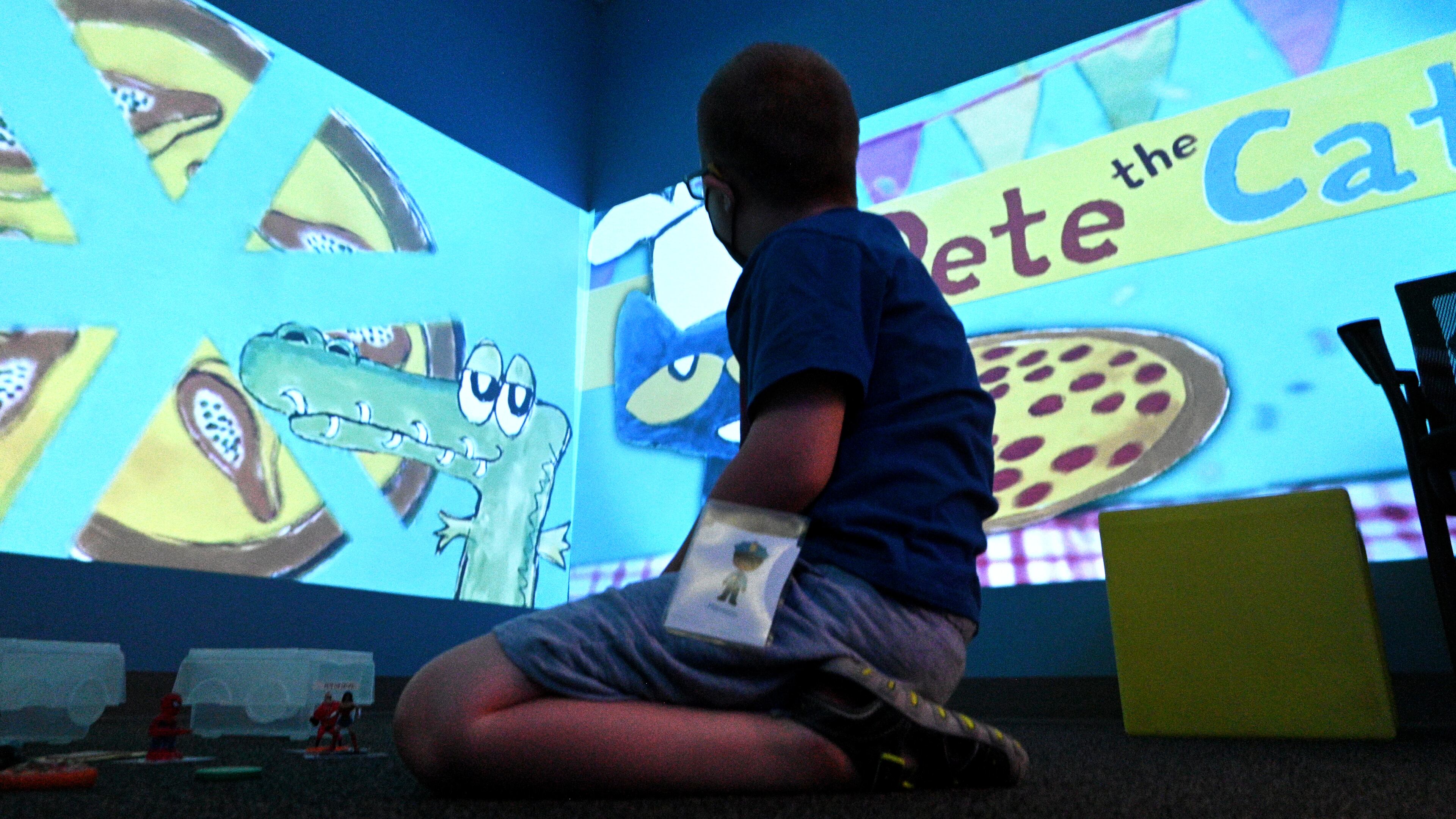 July 12 , 2022 Tucker - A summer camp participant plays and learns using technology in sensory room during a summer camp for children with special needs at Lekotek of Georgia in Tucker on Tuesday, July 12, 2022. Children with and without disabilities play and learn together in an environment that facilitates success. (Hyosub Shin / Hyosub.Shin@ajc.com)