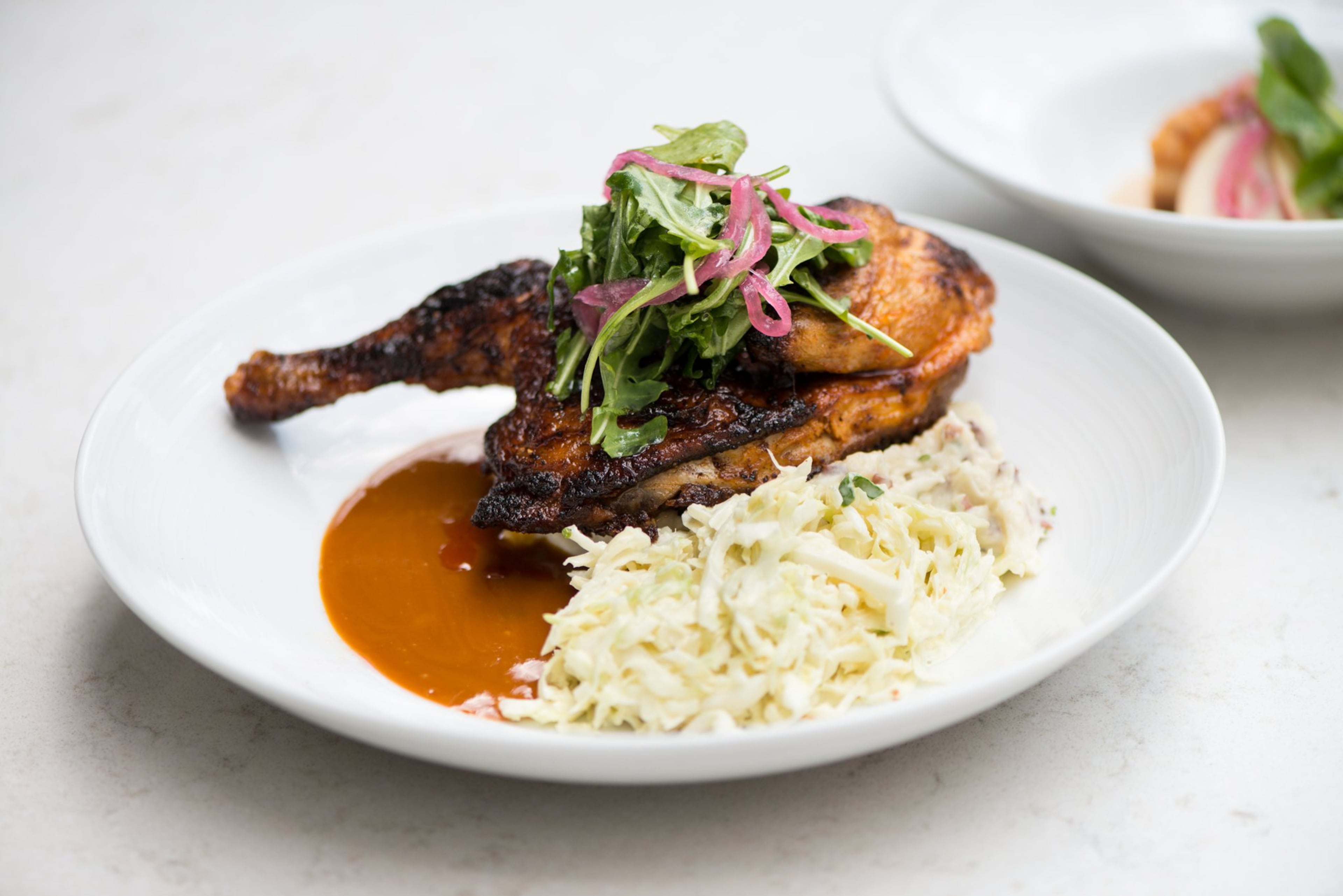 Carolina Style BBQ Chicken with country loaded mash, coleslaw, and Carolina BBQ sauce. Photo credit- Mia Yakel.