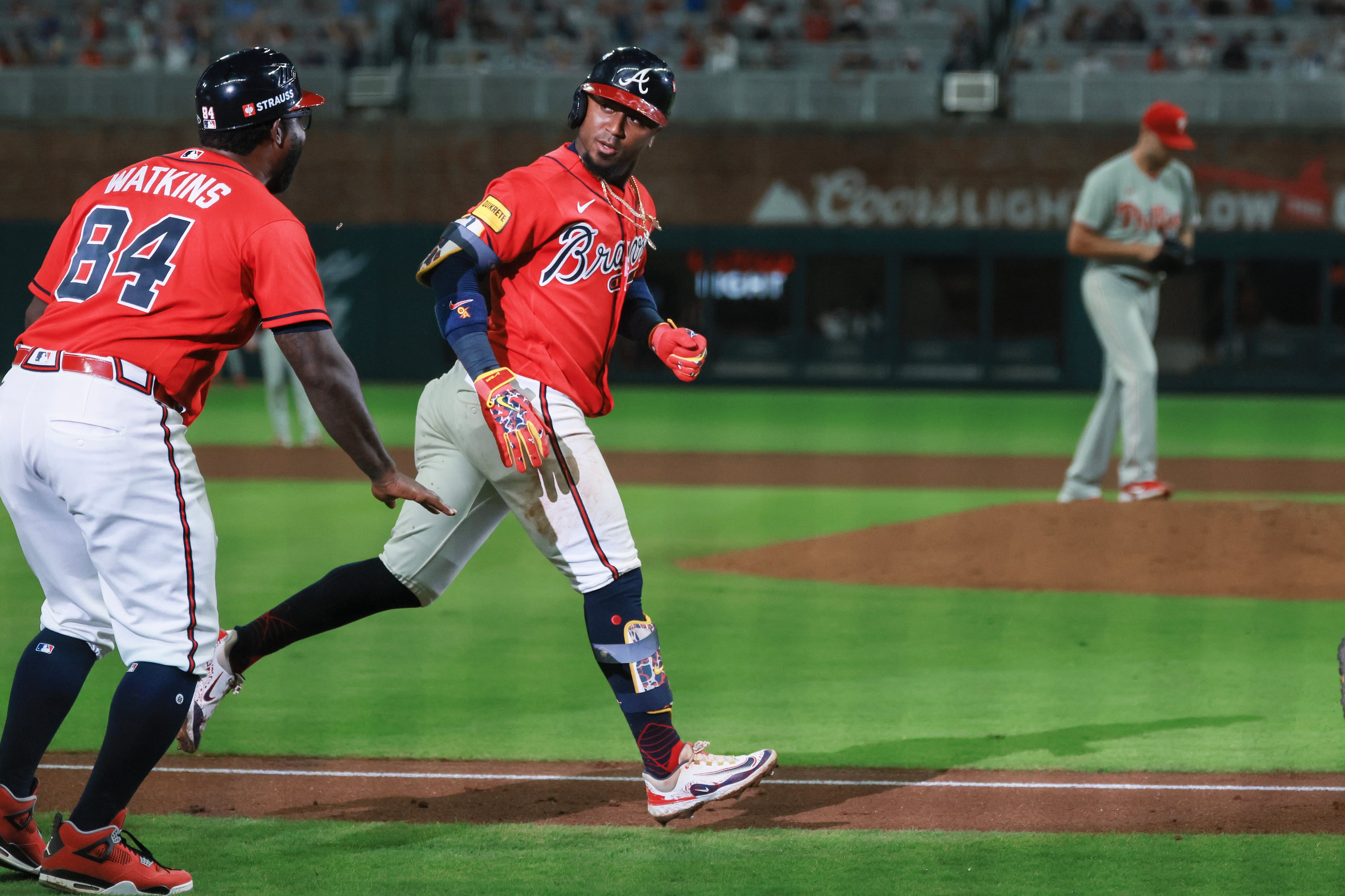 Braves second baseman Ozzie Albies (right) runs past third base coach Tommy Watkins after hitting a two-run home run against the Phillies during Game 3 of their NL Wild Card Series on Thursday, Oct. 1, 2026, in Atlanta. (Jason Getz/AJC)