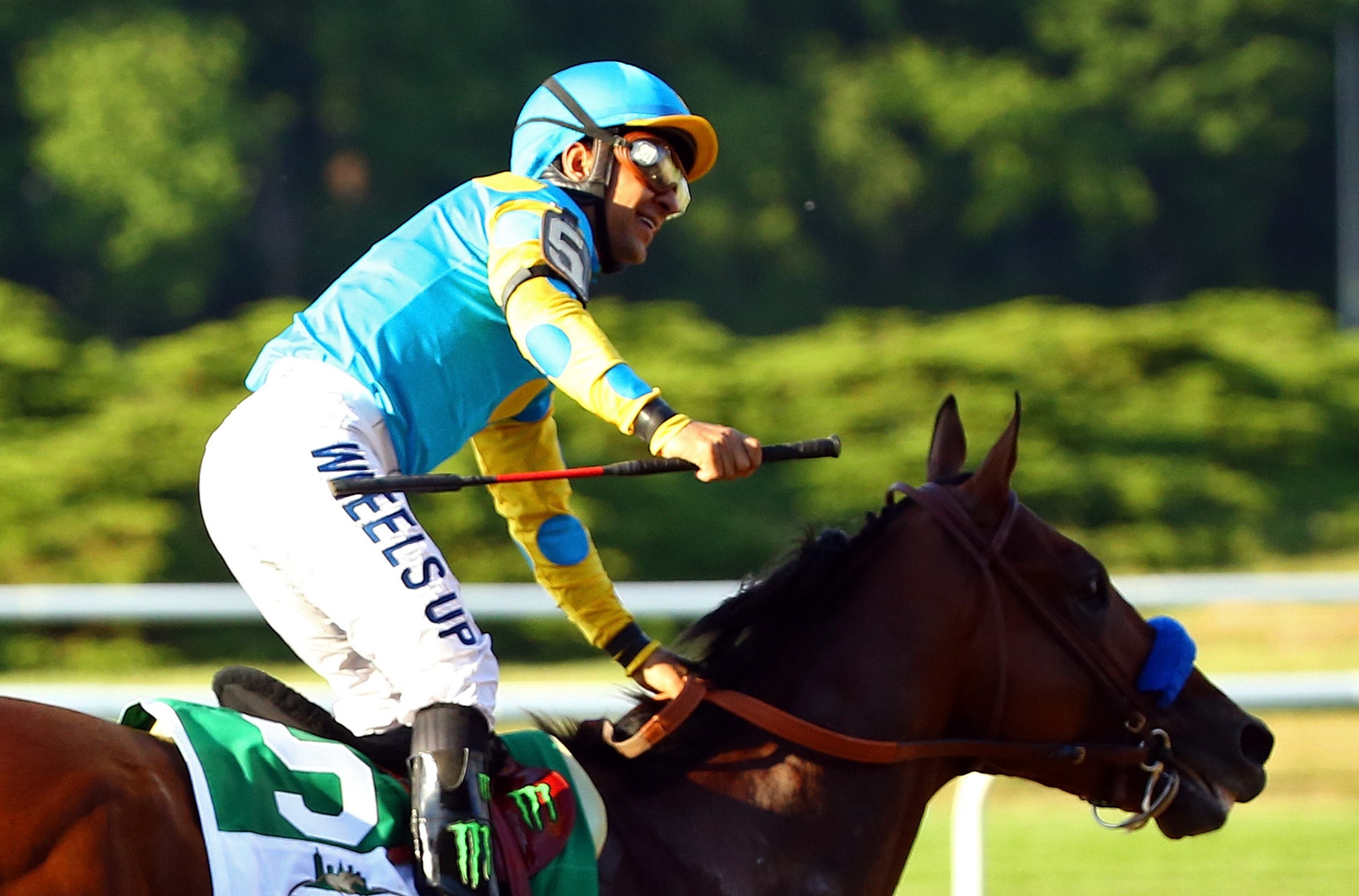 ELMONT, NY - JUNE 06: Victor Espinoza, celebrates atop American Pharoah #5, after winning the 147th running of the Belmont Stakes at Belmont Park on June 6, 2015 in Elmont, New York. With the wins American Pharoah becomes the first horse to win the Triple Crown in 37 years. (Photo by Al Bello/Getty Images)