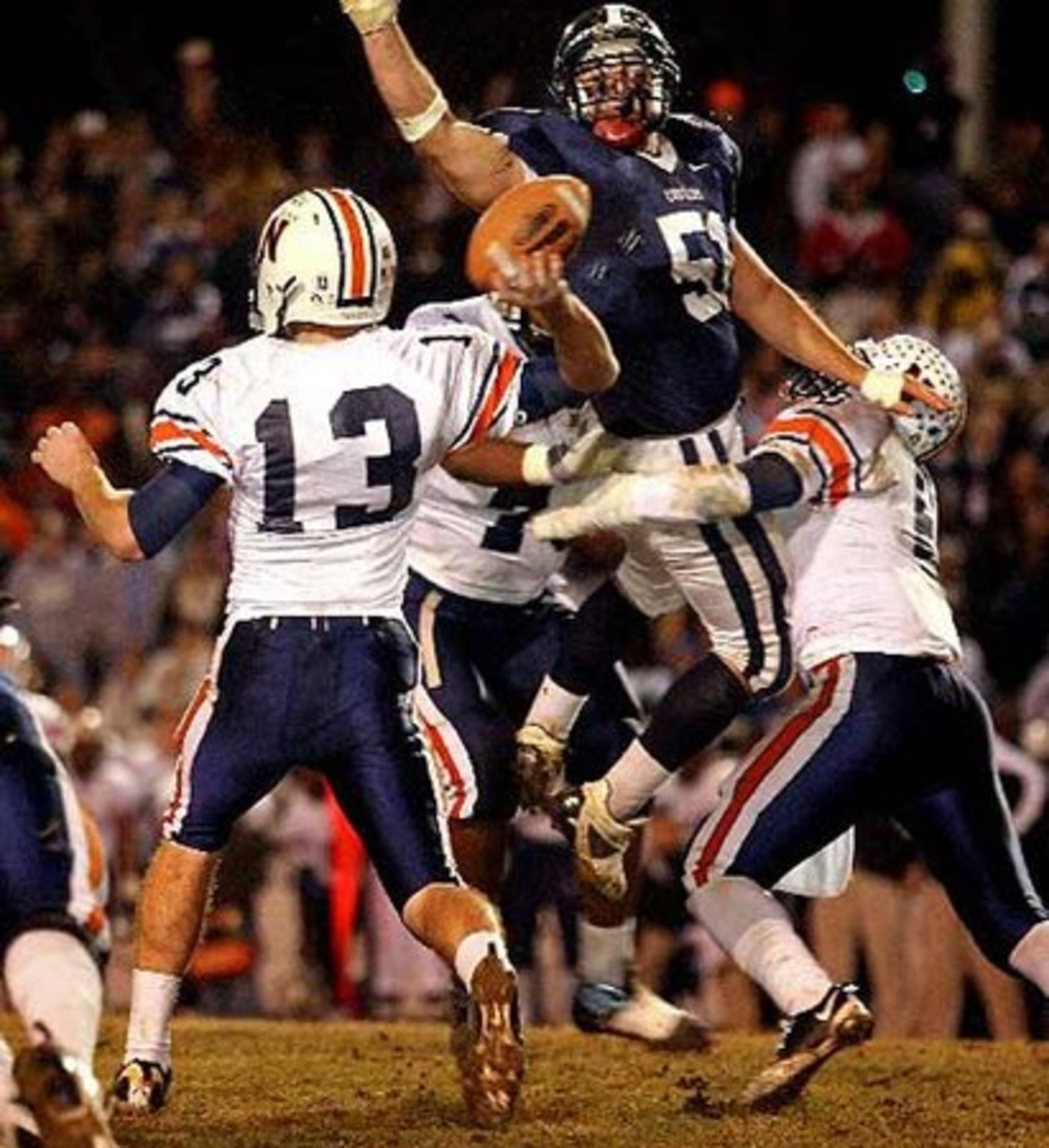 Northside-Warner Robins quarterback Briar Van Brunt (13) has the ball batted down by a jumping Newnan defender Adam Strakose (51).