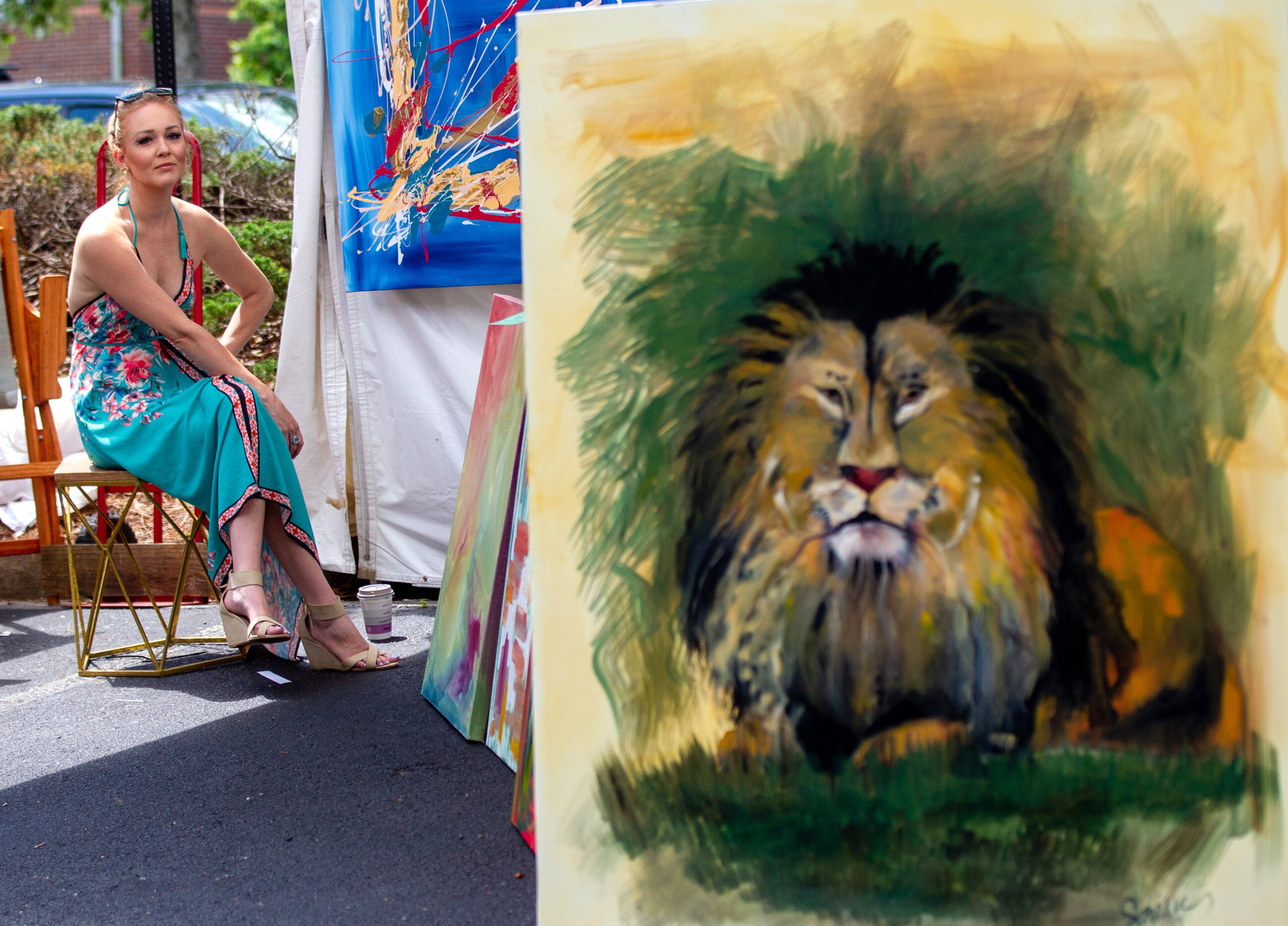 Kate Saville waits for customers in her artist tent during the Roswell Spring Arts and Crafts Festival on Sunday, June 13, 2021. (Photo: Steve Schaefer for The Atlanta Journal-Constitution)