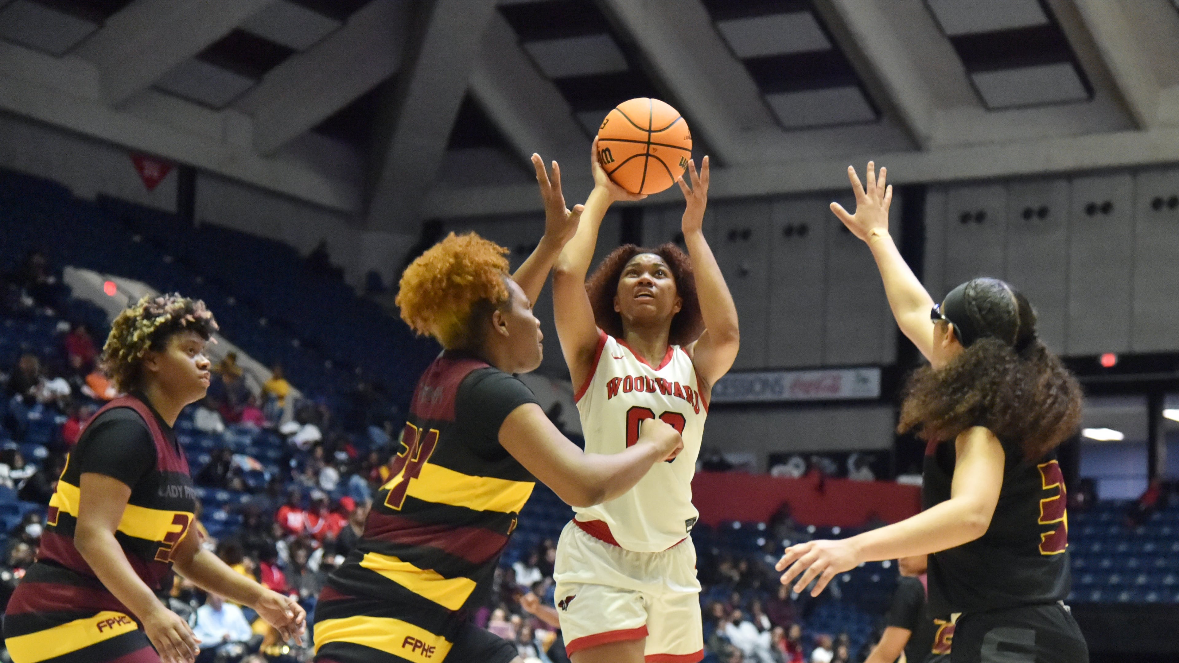 March 10, 2022 Macon - Woodward Academy's Sydney Bowles (0) shoots over Forest Park's Makayla Arnold (34) during the 2022 GHSA State Basketball Class AAAAA Girls Championship game at the Macon Centreplex in Macon on Thursday, March 10, 2022. (Hyosub Shin / Hyosub.Shin@ajc.com)