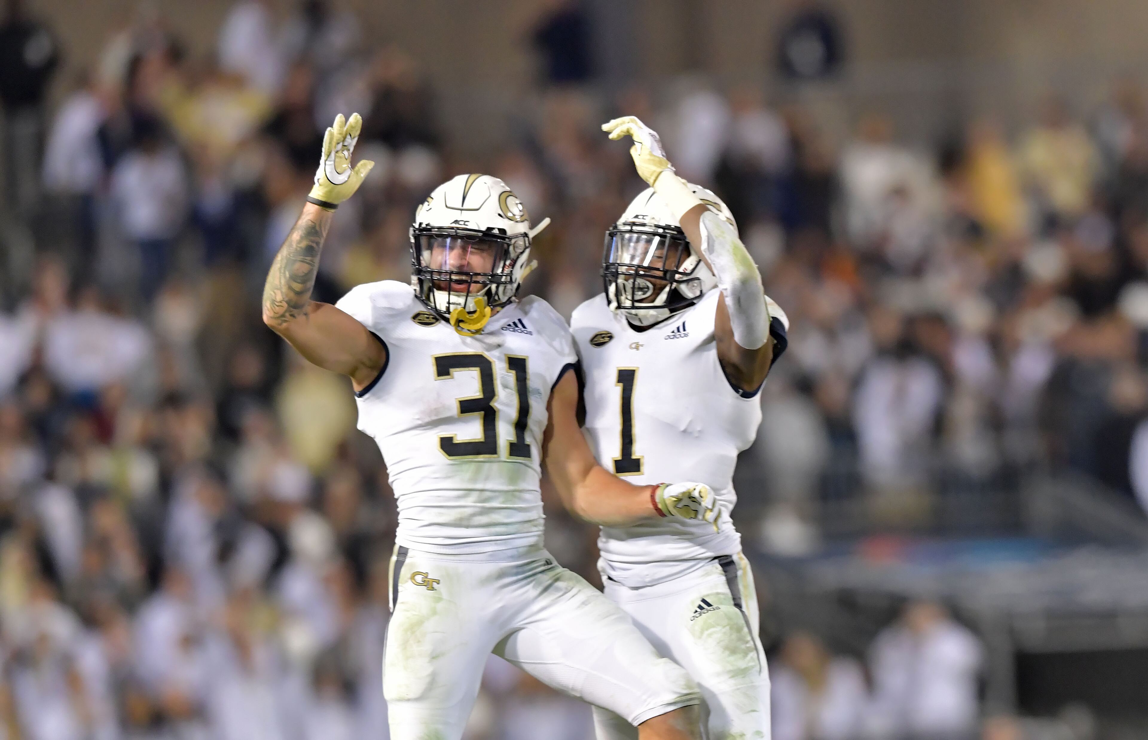 November 10, 2018 Atlanta - Georgia Tech Nathan Cottrell (31) and Qua Searcy (1) celebrate their victory at the end of 4th quarter at Bobby Dodd Stadium on Saturday, November 10, 2018. Georgia Tech won 27 - 21 over the Miami. HYOSUB SHIN / HSHIN@AJC.COM