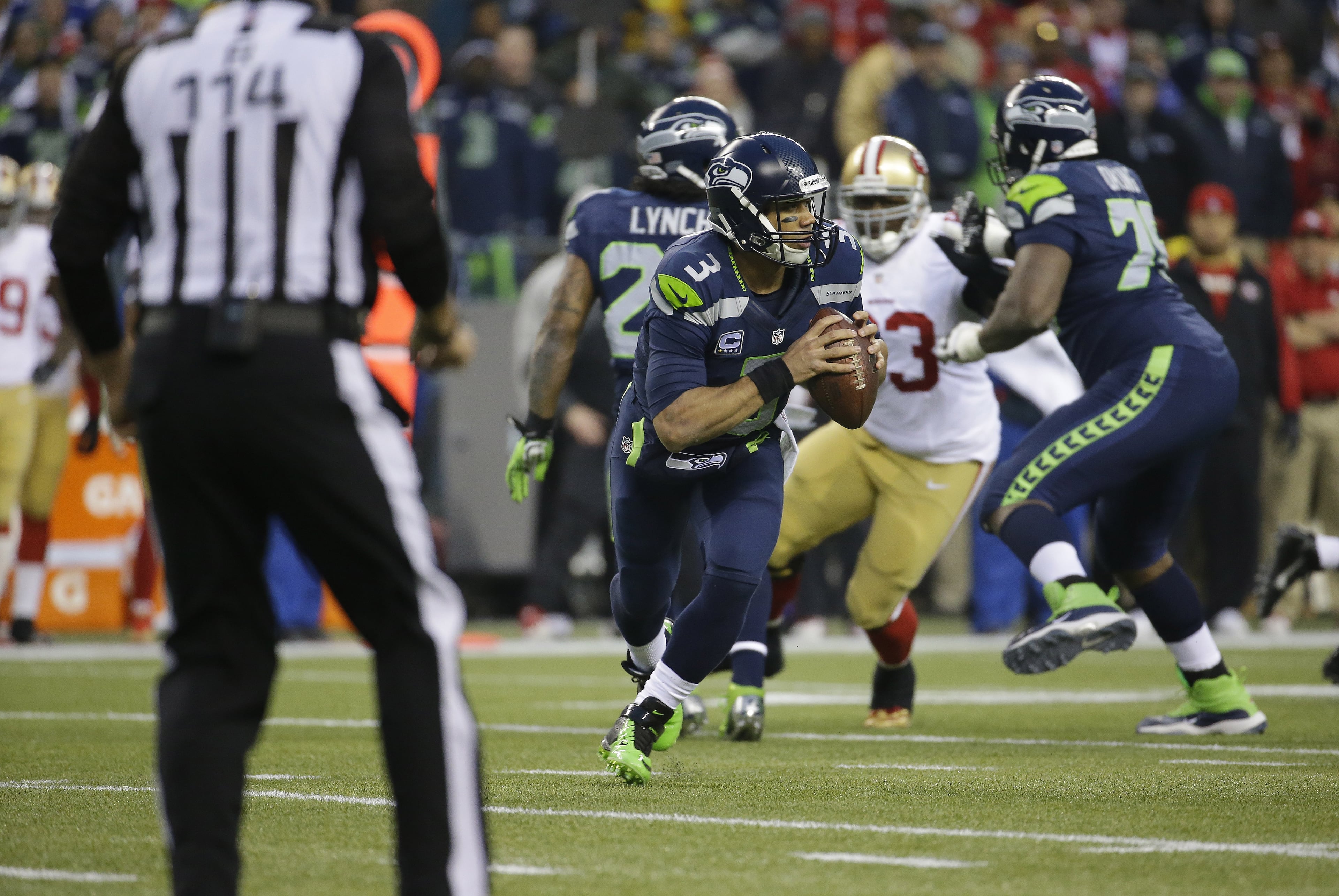 Seattle Seahawks' Russell Wilson works against San Francisco 49ers during the first half of the NFL football NFC Championship game Sunday, Jan. 19, 2014, in Seattle. (AP Photo/Ted S. Warren)
