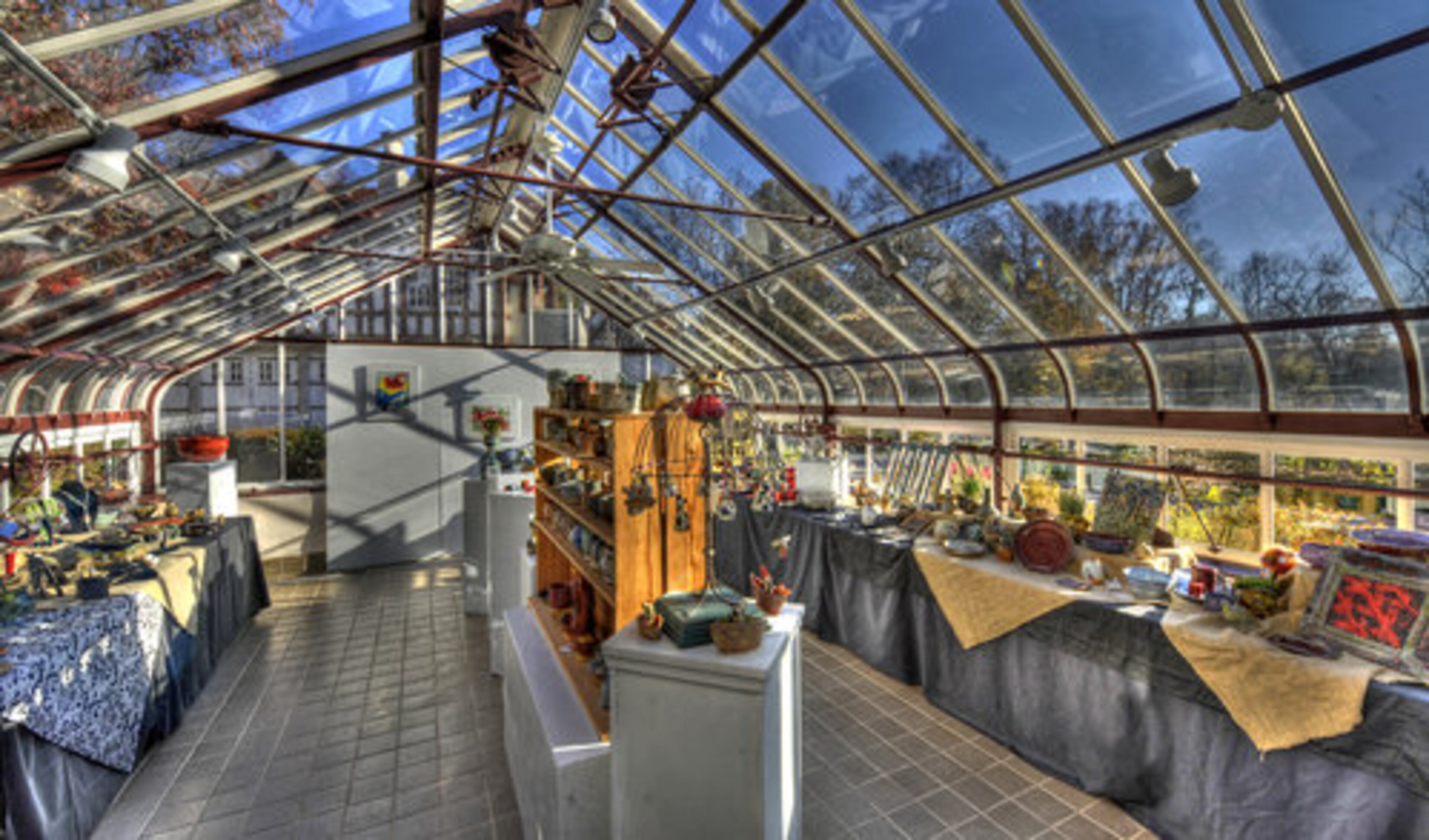 The Callanwolde Conservatory is set up for an artist's market with fine art for sale.