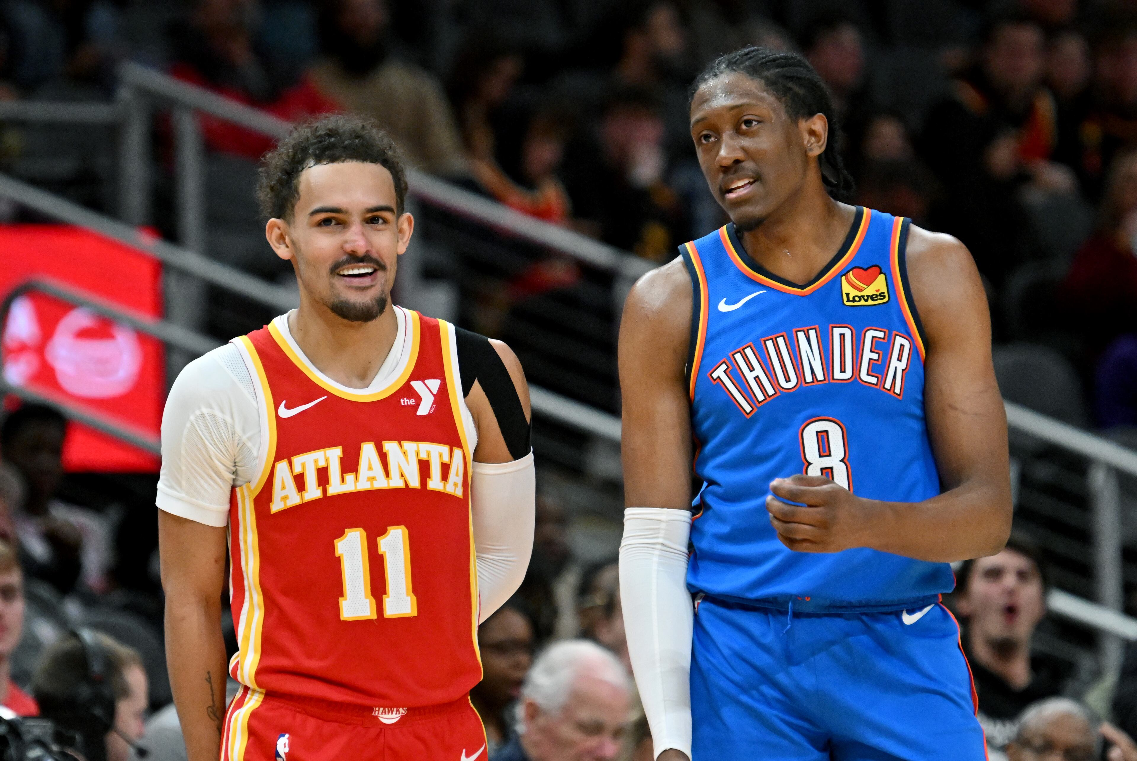 Atlanta Hawks guard Trae Young (11) and Oklahoma City Thunder forward Jalen Williams (8) share a smile during the second half in an NBA basketball game at State Farm Arena, Wednesday, December 3, 2024, in Atlanta. Atlanta Hawks won 141-138 over Oklahoma City Thunder. (Hyosub Shin / Hyosub.Shin@ajc.com)