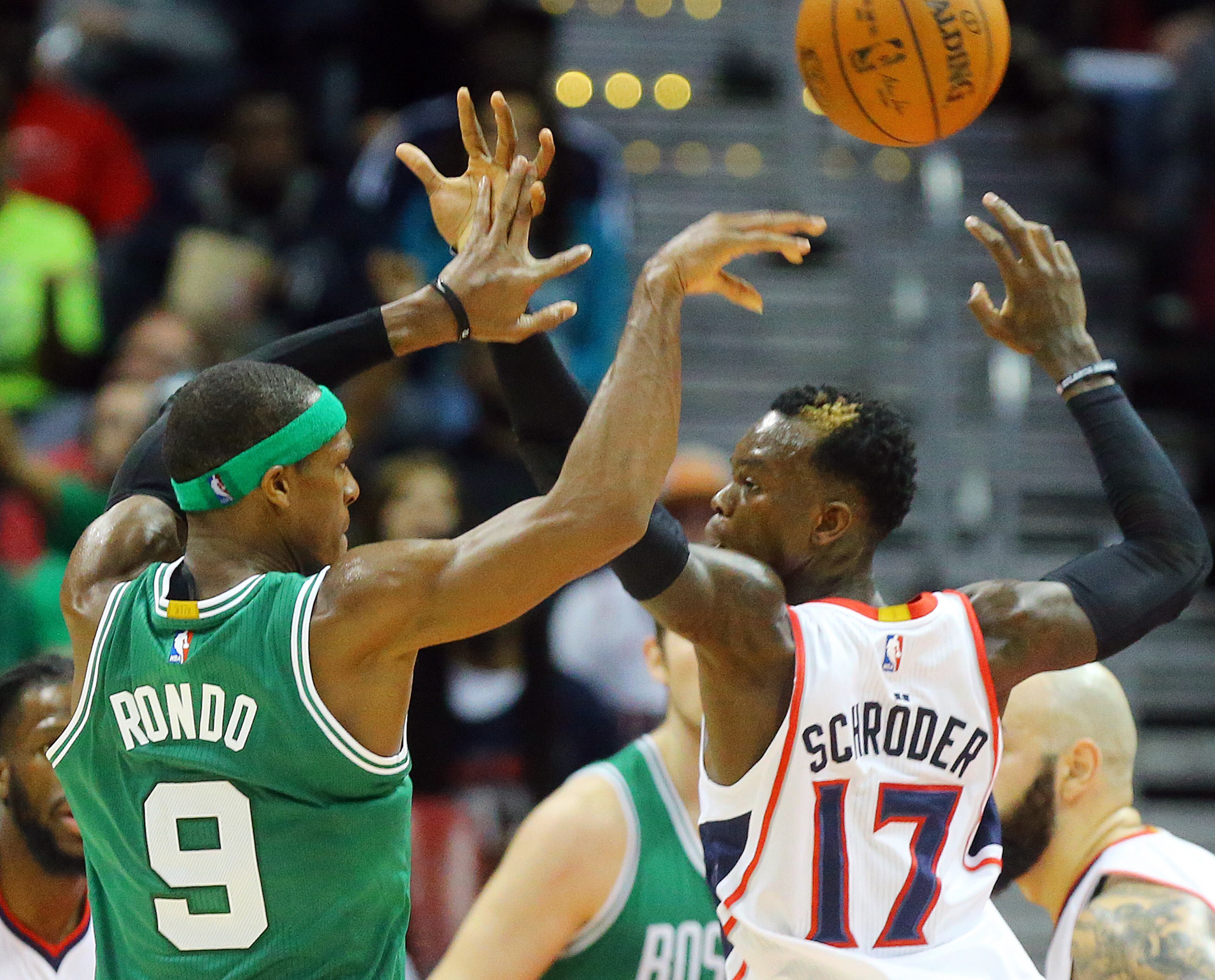 Celtics Rajon Rondo just gets off a pass under pressure from Hawks defender Dennis Schroder during the second half in an NBA basketball game on Tuesday, Dec. 2, 2014, in Atlanta. CURTIS COMPTON / CCOMPTON@AJC.COM