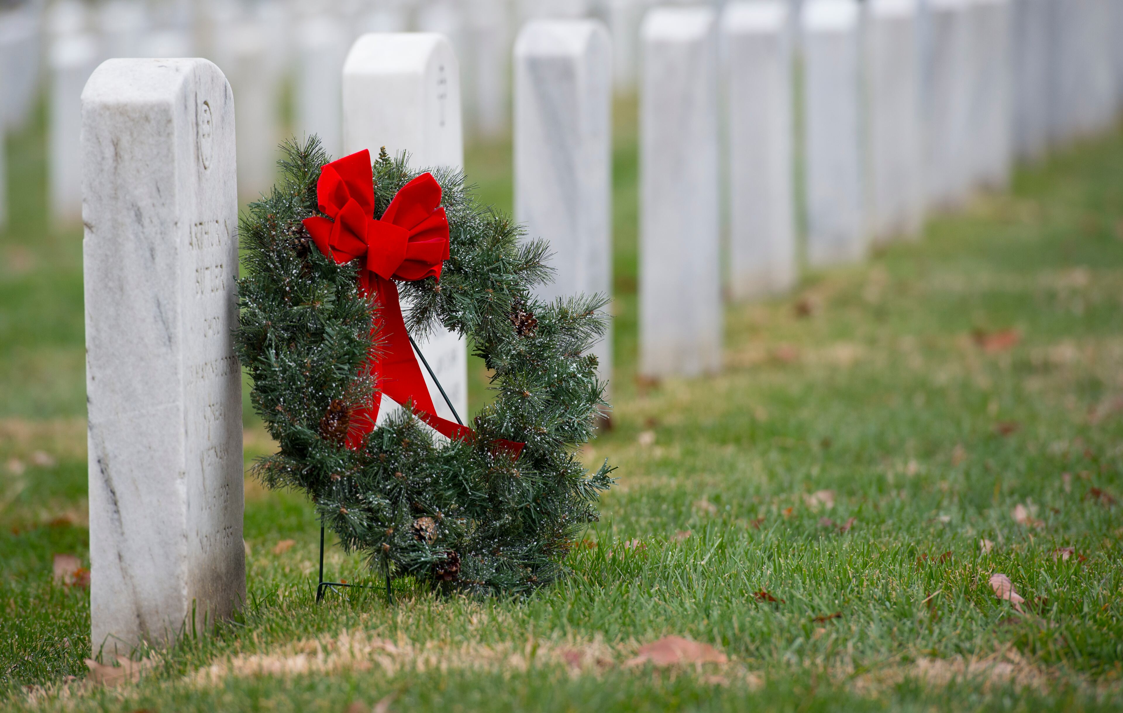 A lone wreath sits next to a headstone during the 2015 National Wreaths Across America event at Arlington National Cemetery December 12, 2015 in Arlington, VA. More than 50,000 volunteers helped to place remembrance wreaths on 230,000 gravestones at Arlington on Saturday. AFP PHOTO/MOLLY RILEY / AFP / MOLLY RILEY (Photo credit should read MOLLY RILEY/AFP/Getty Images)