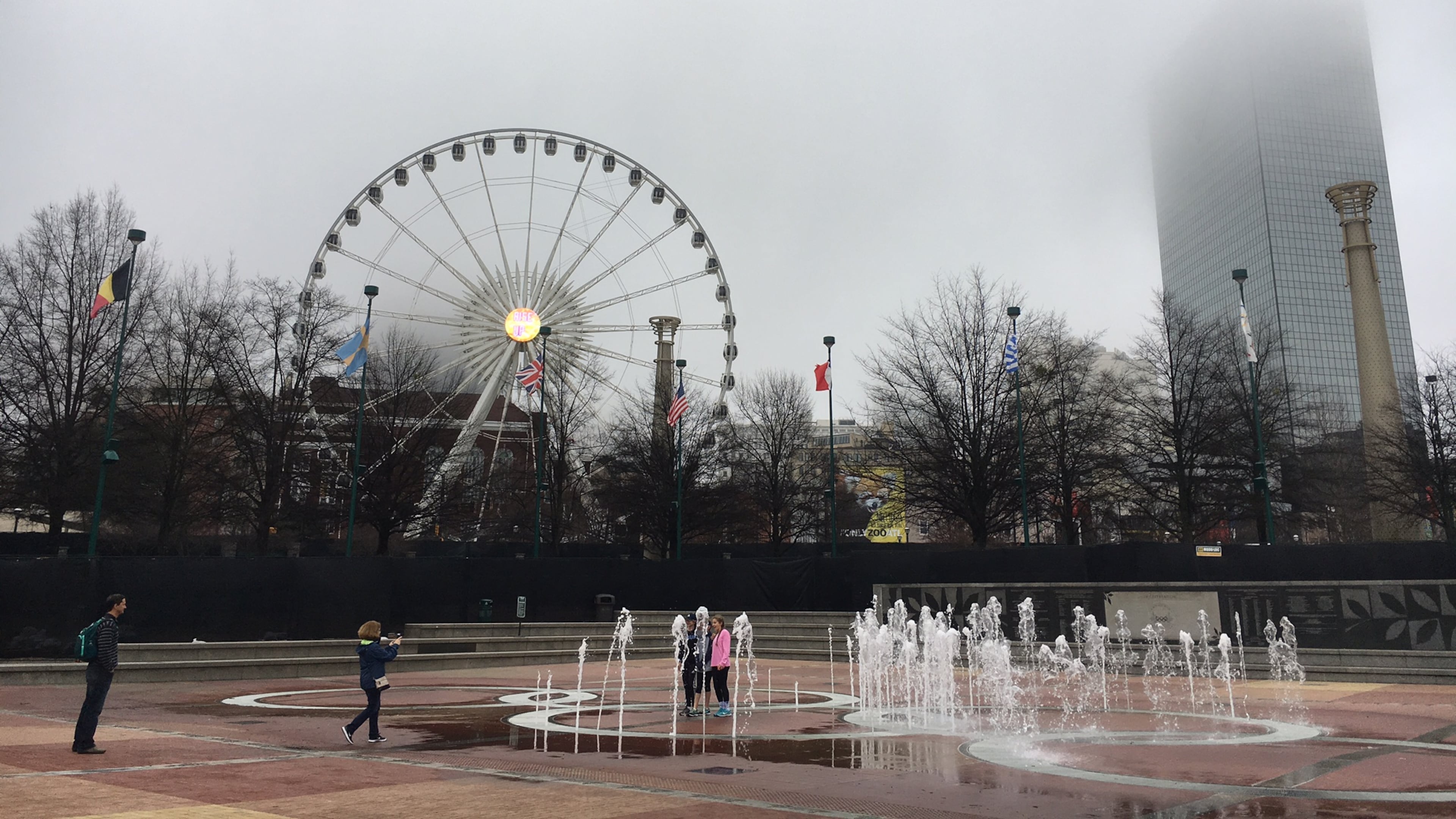 Few fans revel in the fountain at Centennial Olympic Park less than an hour before a Falcons foggy faceoff against the Packers. (Ben Brasch/AJC photo)