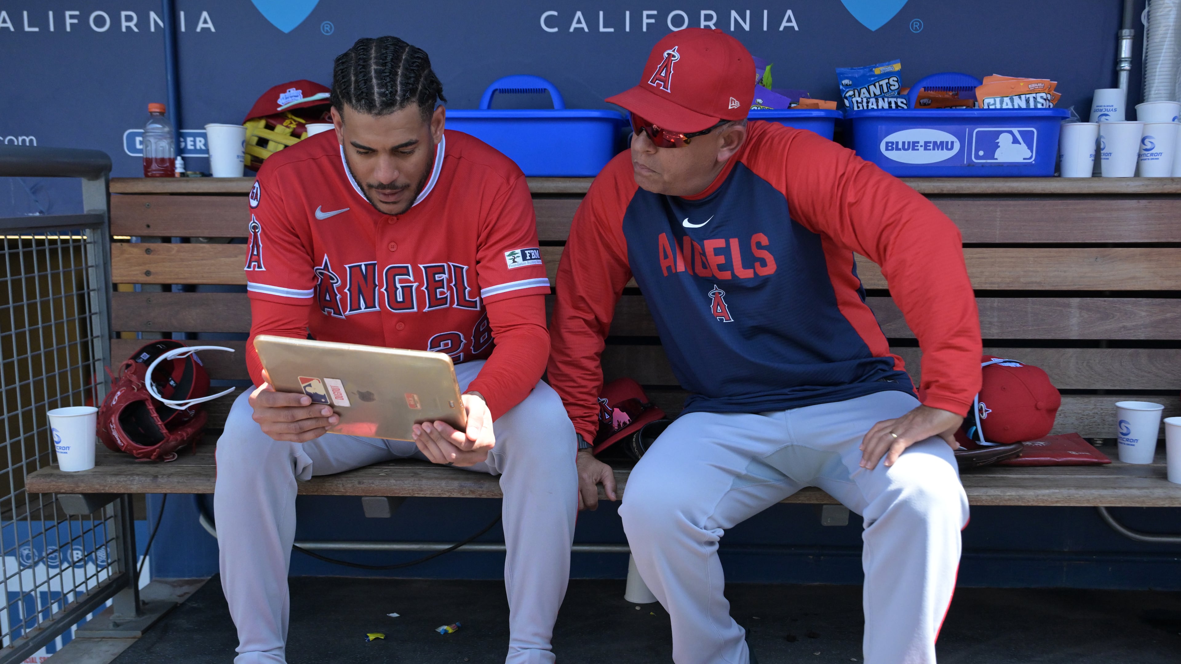 FILE - Los Angeles Angels' Jose Siri, left, looks at an iPad in the dugout with Angels' assistant hitting coach Jobel Jiménez during a baseball game against the Los Angeles Dodgers, June 7, 2026, in Los Angeles. (AP Photo/Jayne Kamin-Oncea, File)
