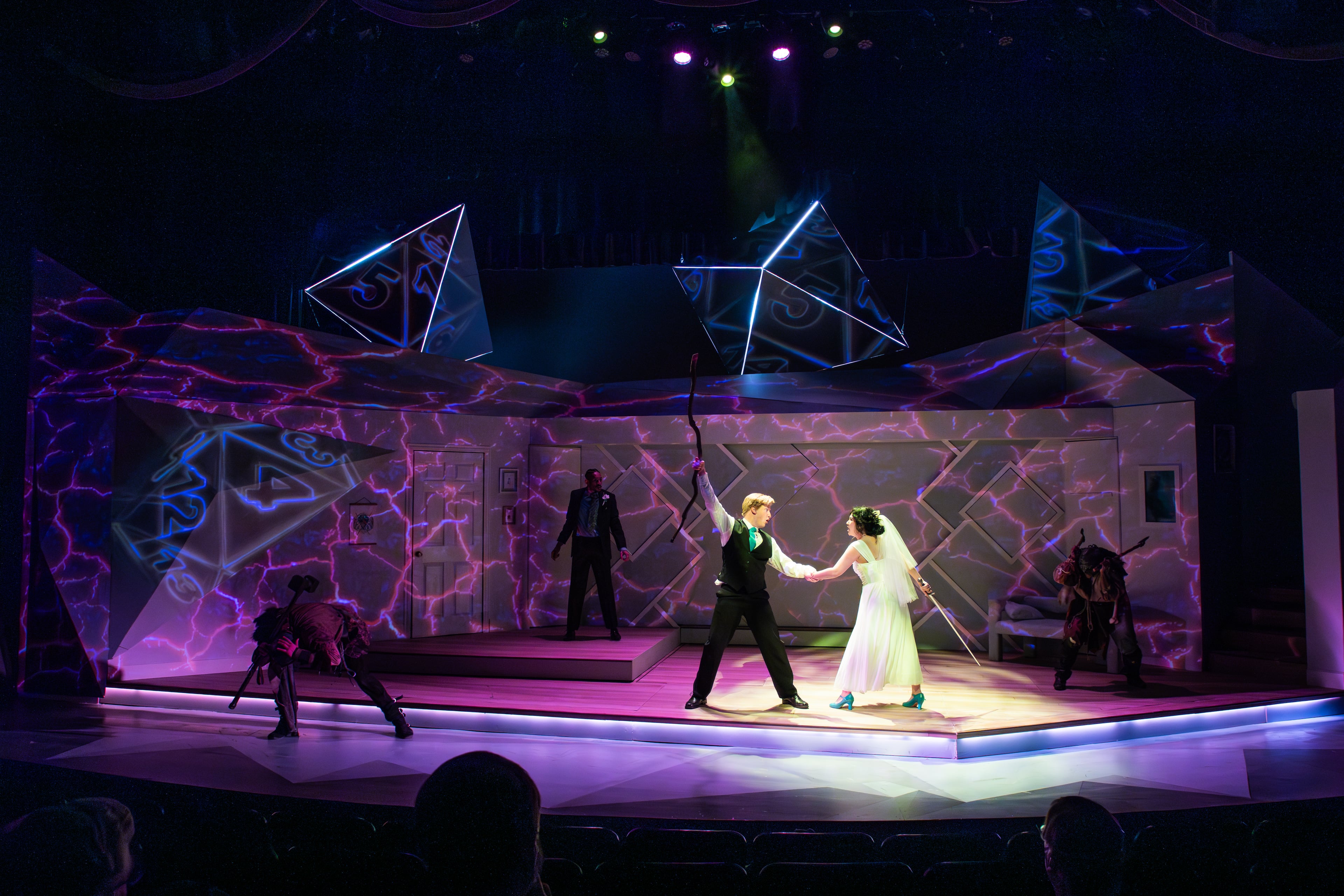 Cole Ferguson (Dave) and Michelle Pokopac (Meg) take on a group of fearsome monsters crashing their wedding day. (Courtesy of Aurora Theatre/Casey Gardner Ford)