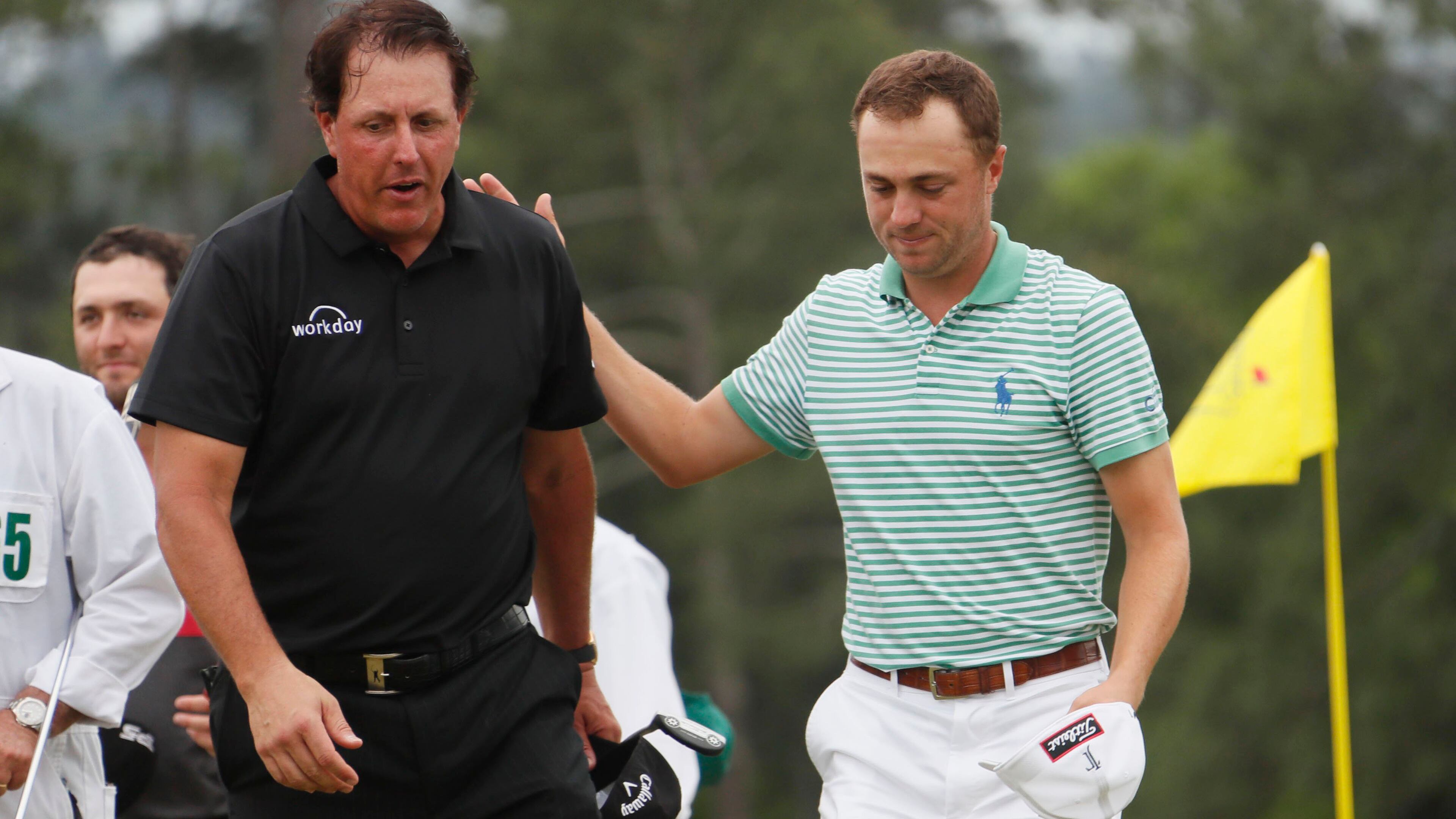 Justin Thomas and Phil Mickelson leave 18 after playing in the final round of the Masters Tournament Sunday, April 14, 2019, at Augusta National Golf Club in Augusta.