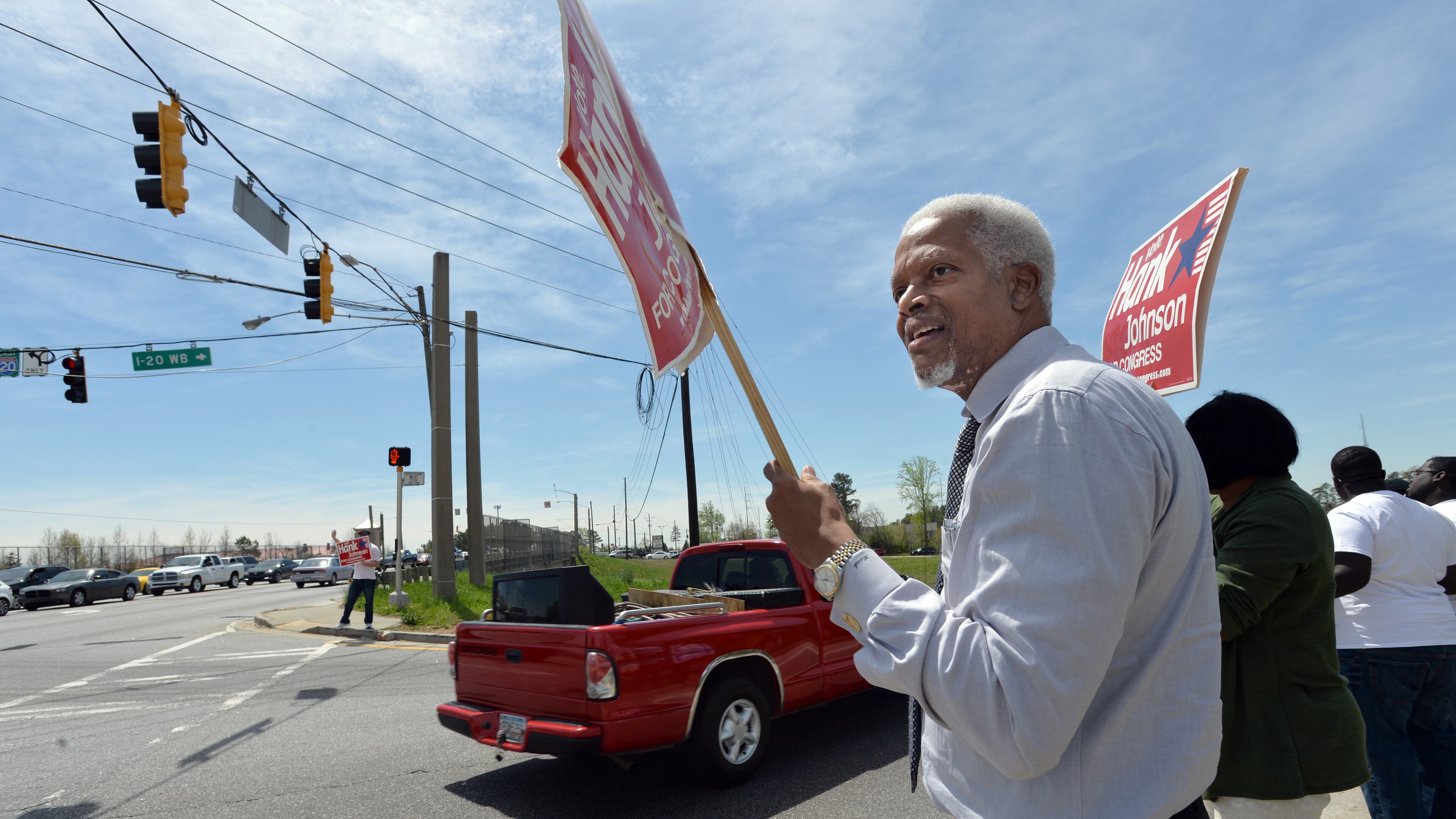April 5, 2014 Lithonia - Congressman Hank Johnson (left) and his supporters wave at traffic near Hank Johnson Campaign Head Quarter in Lithonia on Saturday, April 5, 2014. This is the first in an occasional series analyzing Georgia's five competitive congressional primary races ahead of the May 20 vote, as the state's delegation to Washington is set to go through a historic shift. Hank Johnson is in the middle of his toughest fight yet to hold onto his Fourth District congressional seat. HYOSUB SHIN / HSHIN@AJC.COM Congressman Hank Johnson (left) and his supporters wave at traffic near Hank Johnson Campaign Head Quarter in Lithonia on Saturday, April 5, 2014. (AJC/Hyosub Shin)