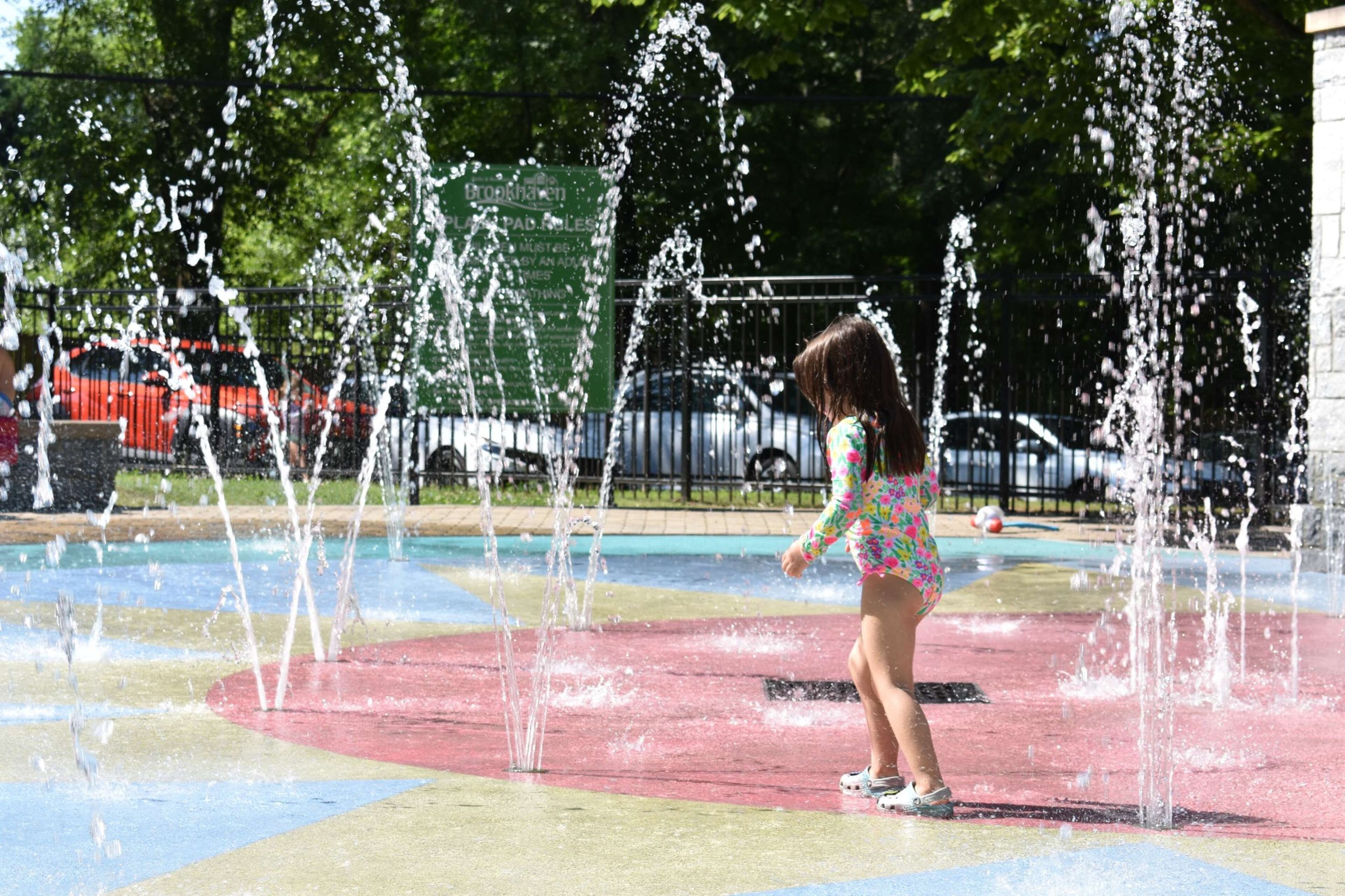 Button-activated spray features and a water curtain make Brookhaven’s Ashford Park Splash Pad a popular destination for cooling off. (Courtesy of the city of Brookhaven)