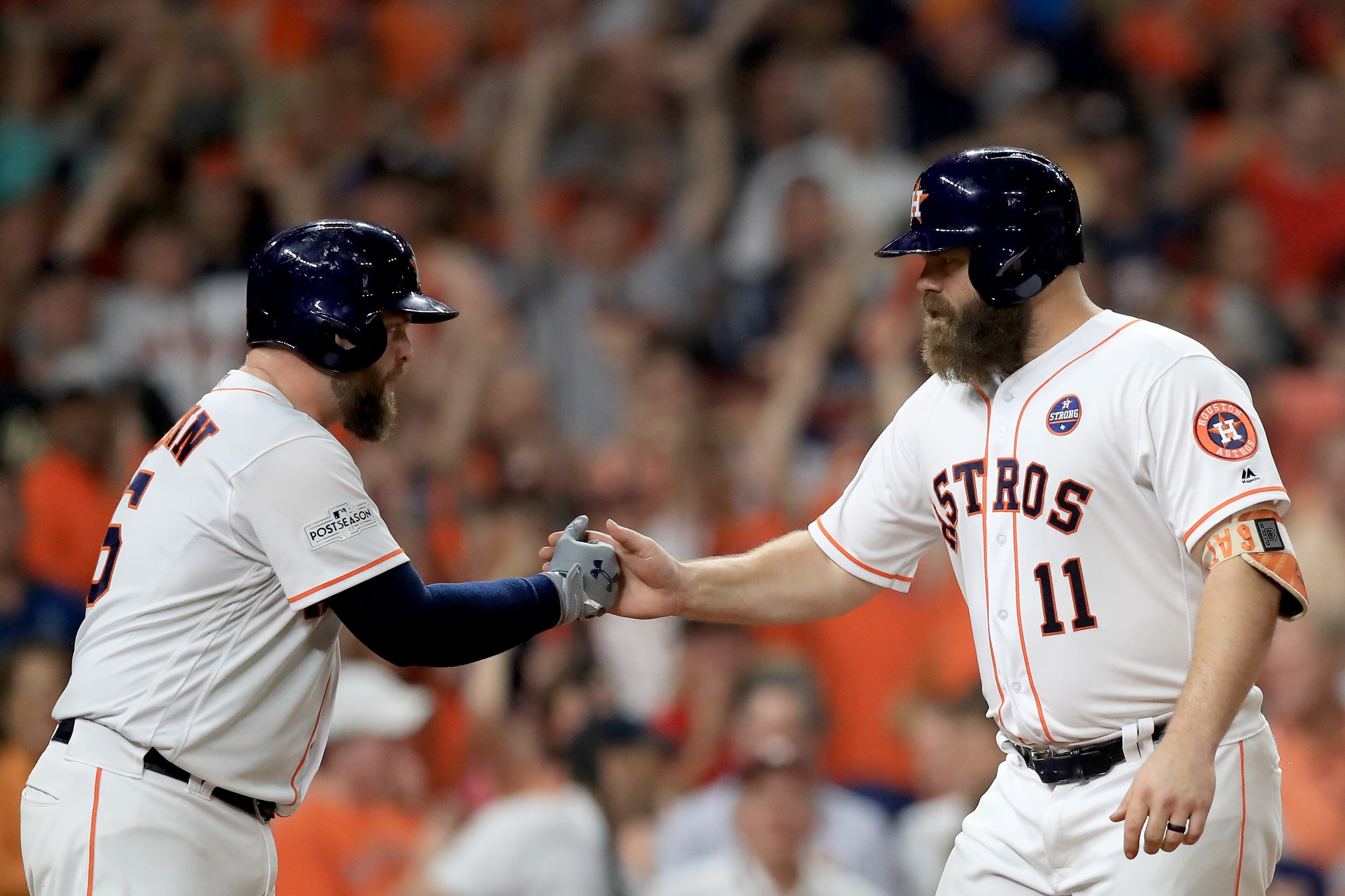 HOUSTON, TX - OCTOBER 21: Evan Gattis #11 of the Houston Astros celebrates with Brian McCann #16 after hitting a a solo home run against CC Sabathia #52 of the New York Yankees during the fourth inning in Game Seven of the American League Championship Series at Minute Maid Park on October 21, 2017 in Houston, Texas. (Photo by Ronald Martinez/Getty Images)