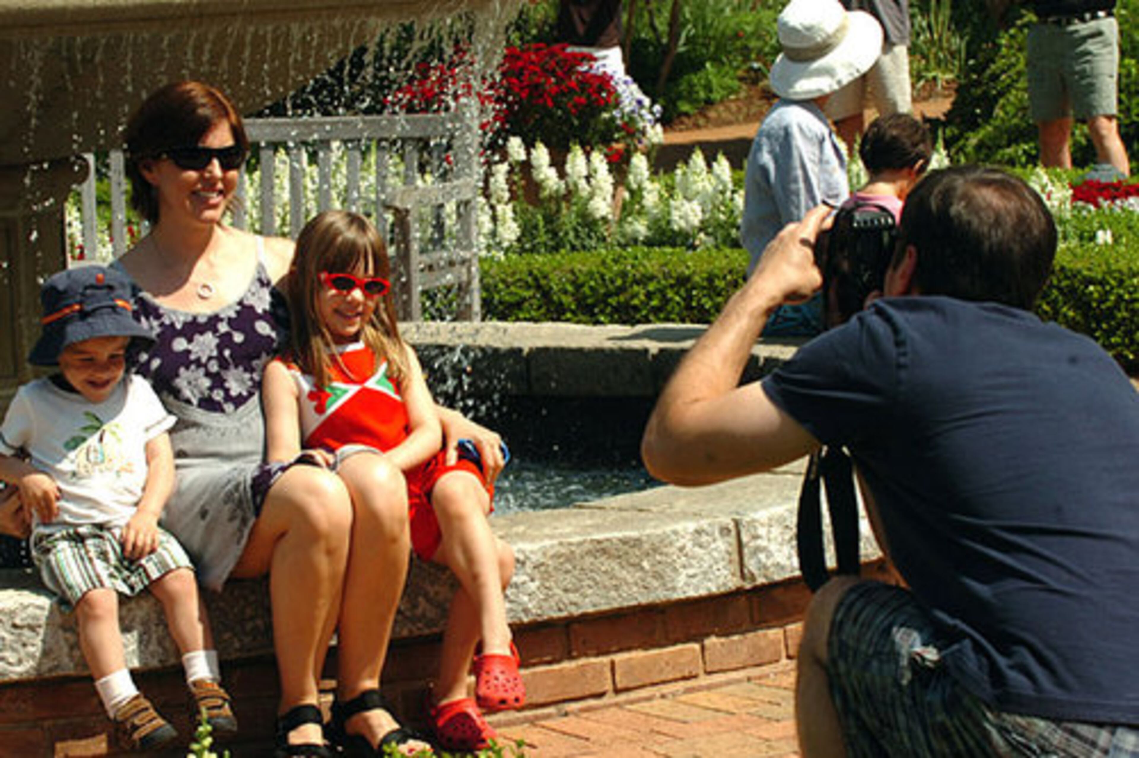 Erin Steele and children Grant Weinstein, 2 and Claire Weinstein, 4, pose for dad, Rich Weinstein, during a visit to the Atlanta Botanical Garden on Mother's Day.