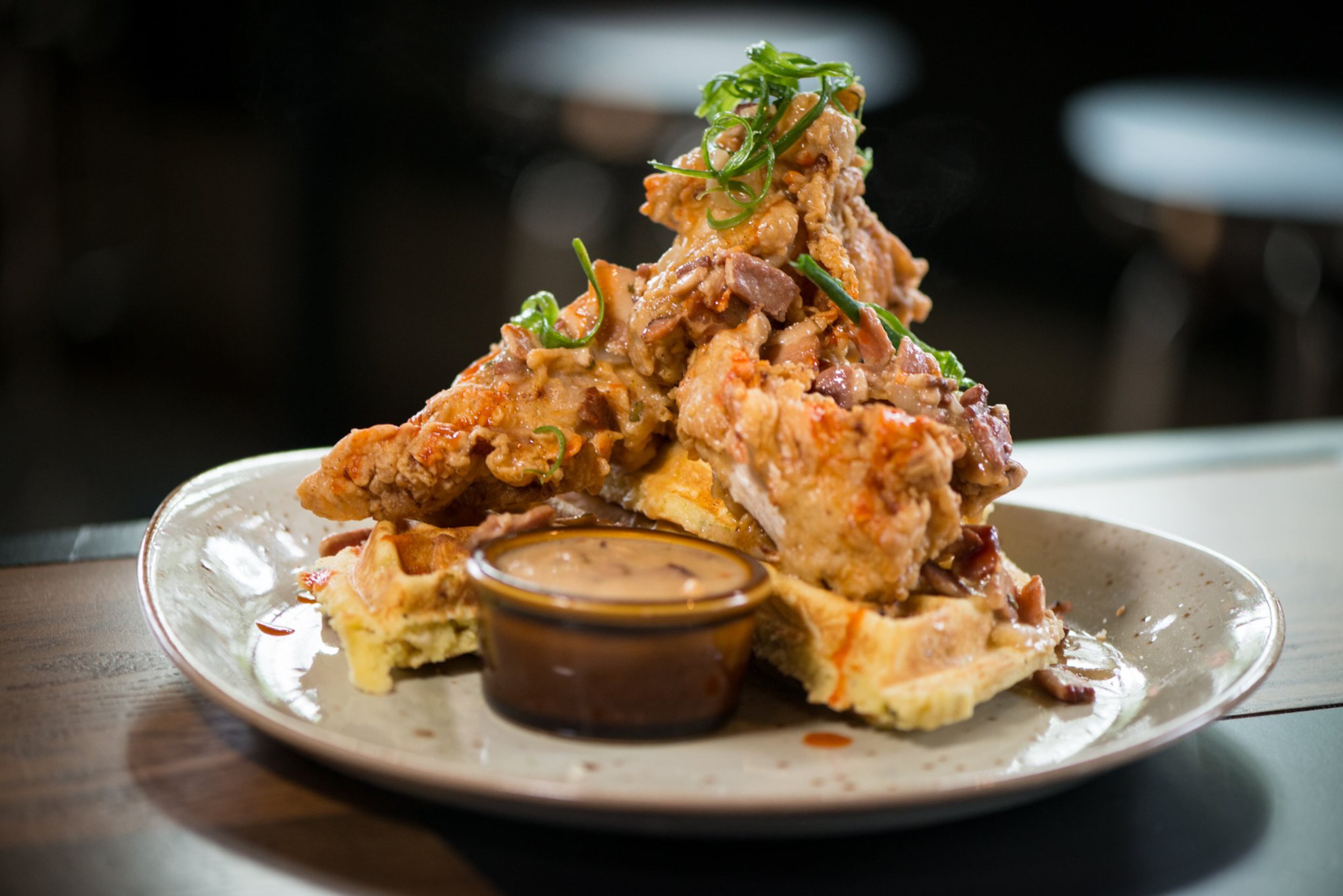 Fried Chicken and Green Chili Waffles with cheddar, bacon red-eye gravy, louisiana hot sauce. Photo credit- Mia Yakel.