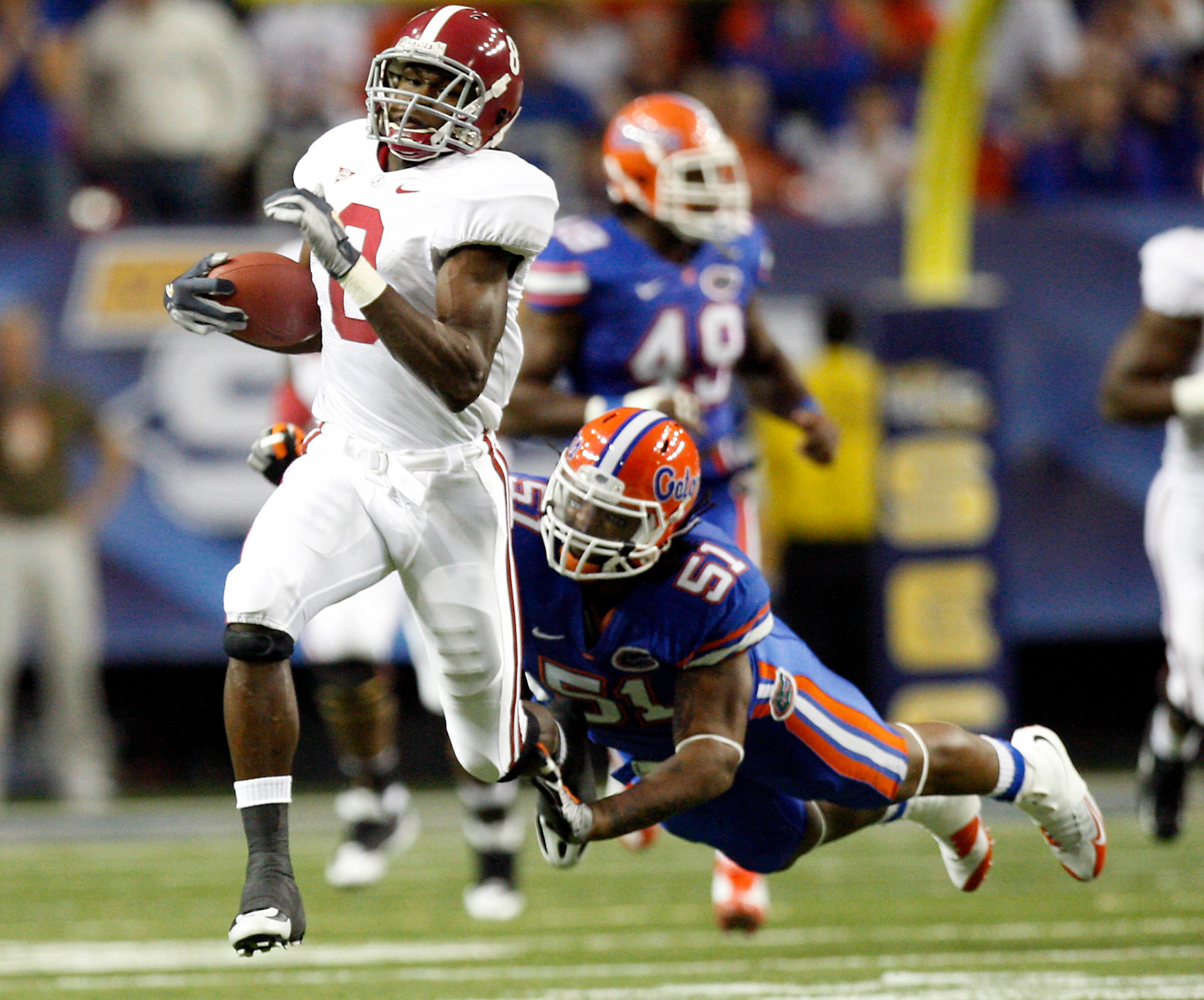 Alabama wide receiver Julio Jones (8) runs a 64-yard run after the catch as Florida linebacker Brandon Spikes (51) dives and fails to make the tackle in the first quarter of their SEC Championship game Saturday afternoon in the Georgia Dome in Atlanta, Ga., December 6, 2008.