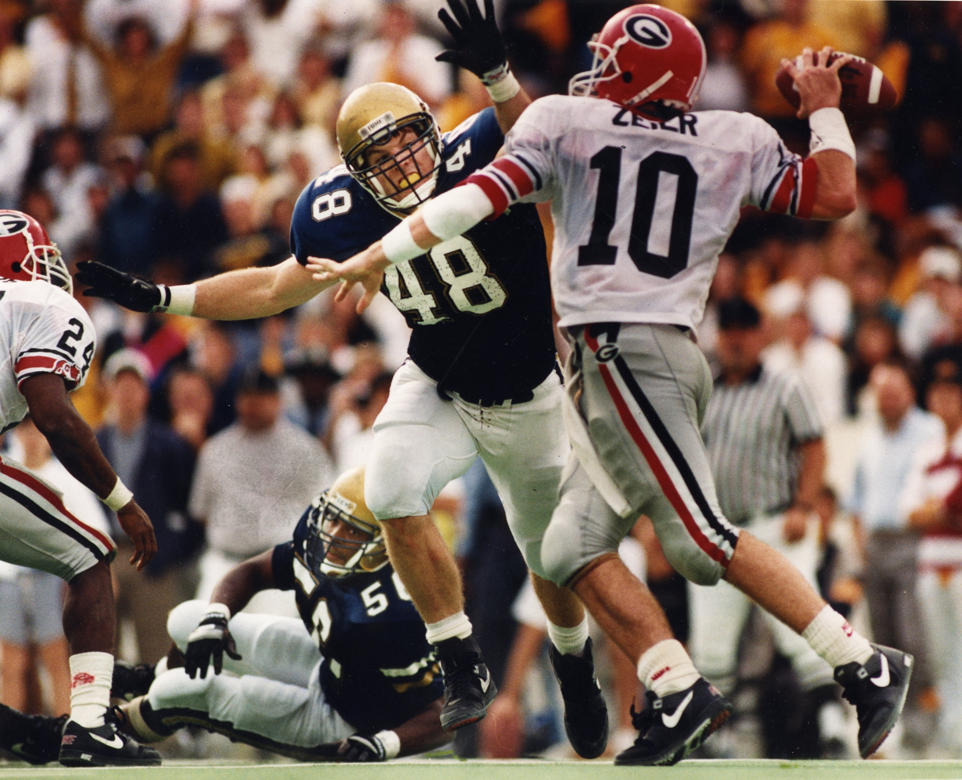 Eric Zeier made his mark during his four seasons (1991-94) under center at UGA, passing for 11,153 yards and establishing several school and SEC records. Zeier started on the '92 squad which finished 10-2 and won the Citrus Bowl.