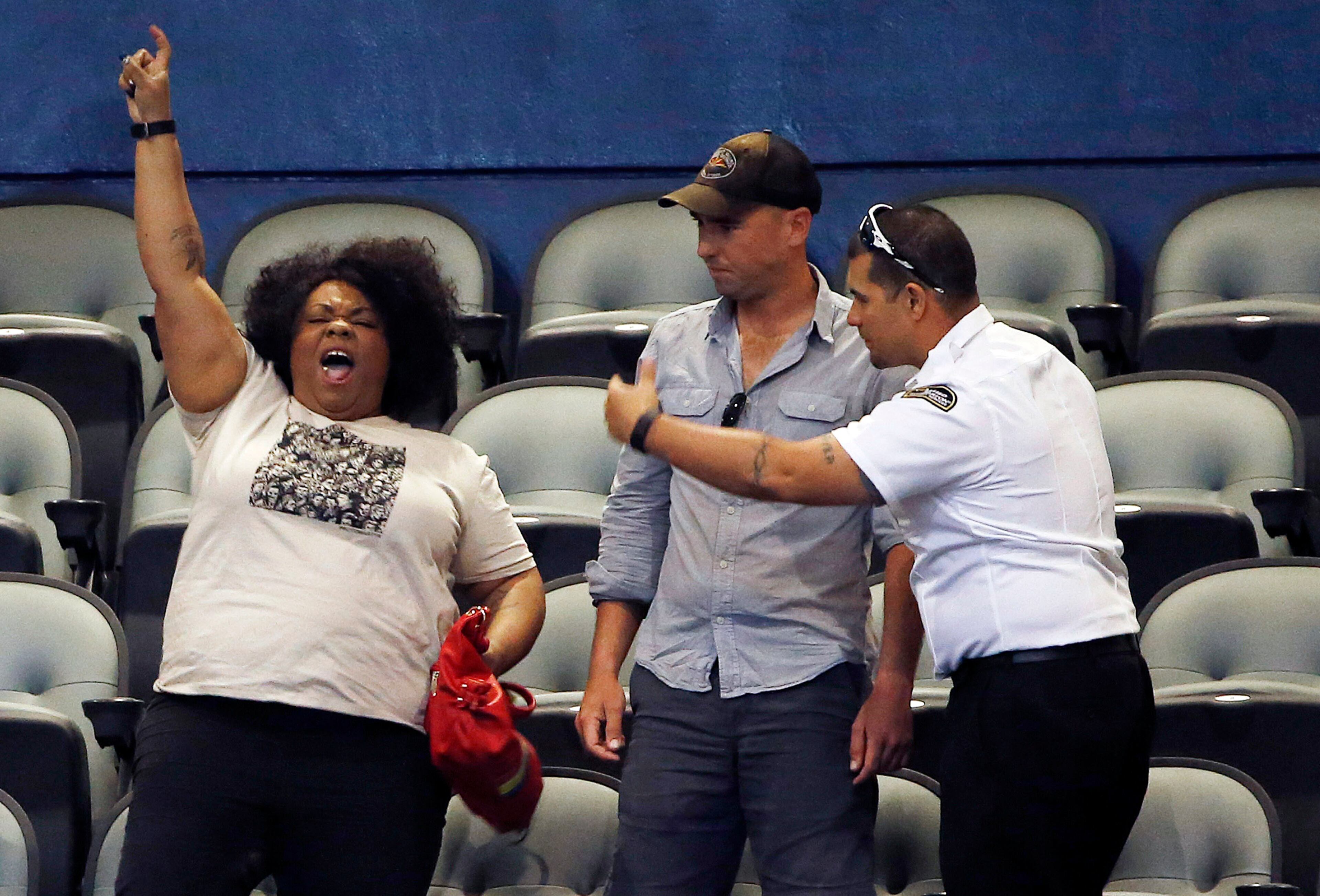 A security official motions to escort a an anti-Trump protester to leave before Republican presidential candidate Donald Trump spoke at a campaign rally Saturday, March 19, 2016, in Tucson, Ariz. (AP Photo/Ross D. Franklin)
