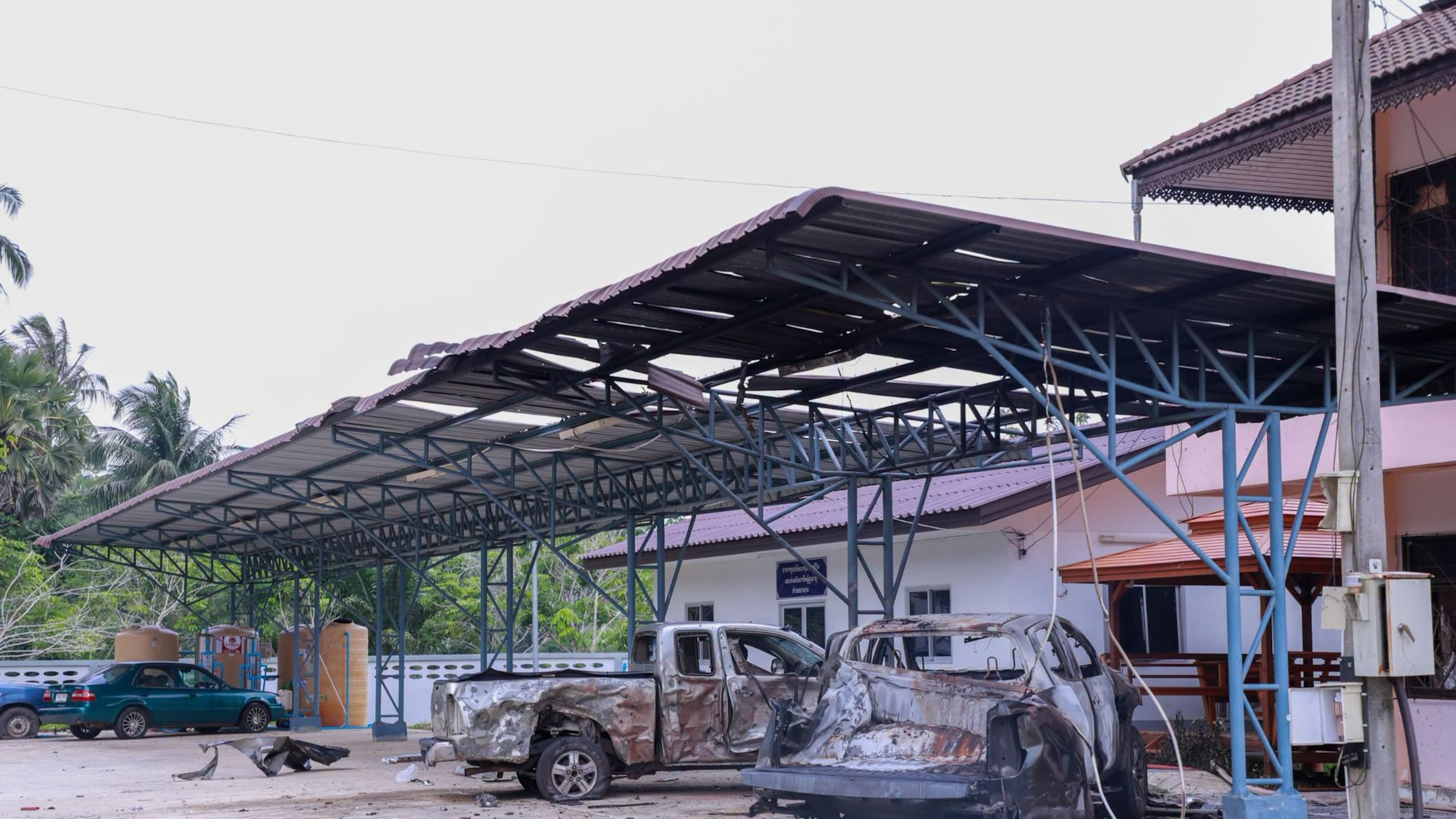 This image provided by The Government's Internal Security Operations Command, shows vehicles damaged the night before by arson at a local government office in Sri Sakhon Subdistrict in Narathiwat province, Thailand, Sunday, Aug. 23, 2026. (The Government's Internal Security Operations Command via AP)