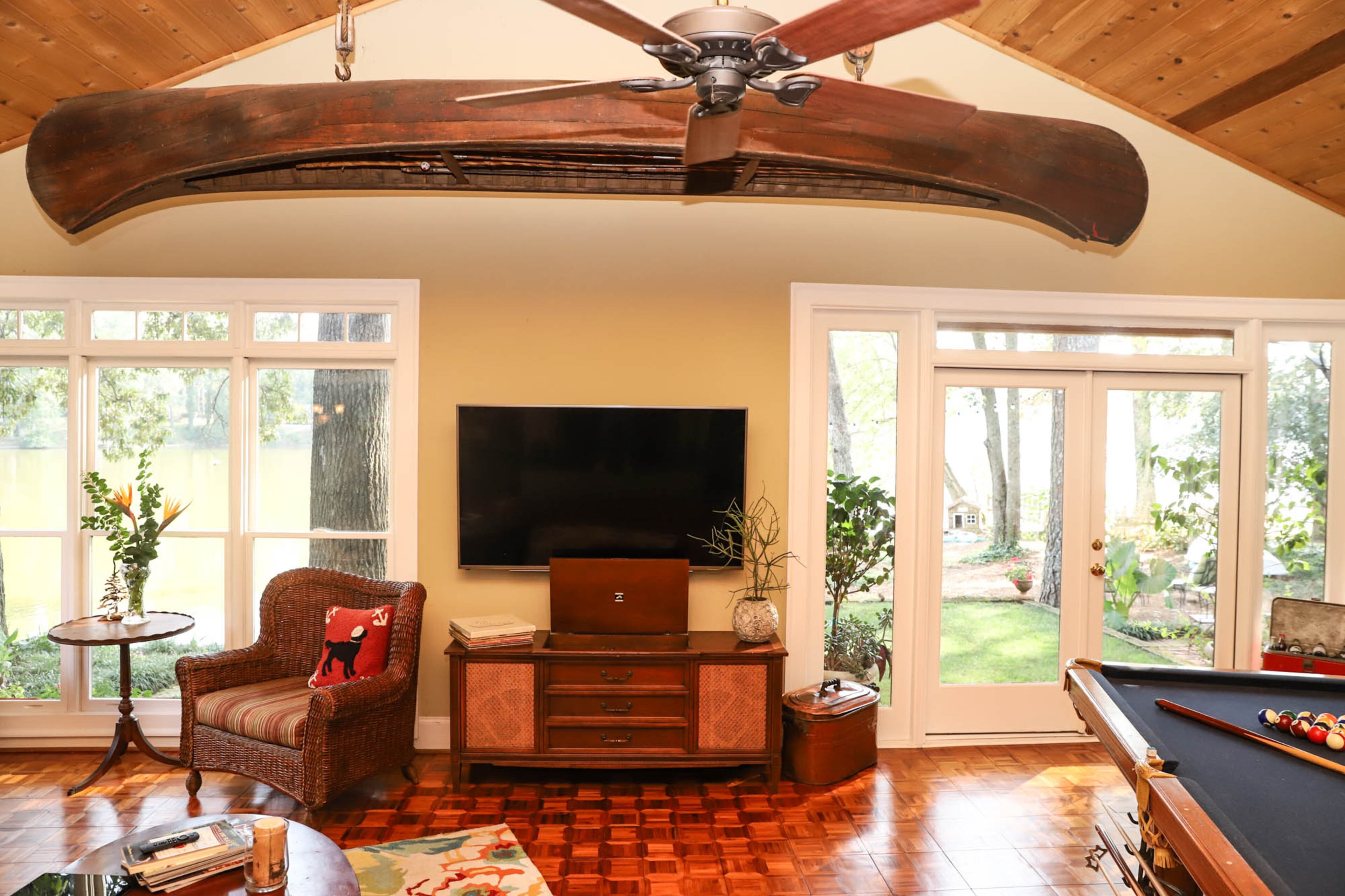 A 1911 Kennebec open gunwale canoe — a gift to David Sellers from his wife Megan Sellers and their two daughters — hangs from the ceiling of the lake room in the Sellers’ Jonesboro home. Text by Shannon Dominy. Photo by Reynolds Rogers.