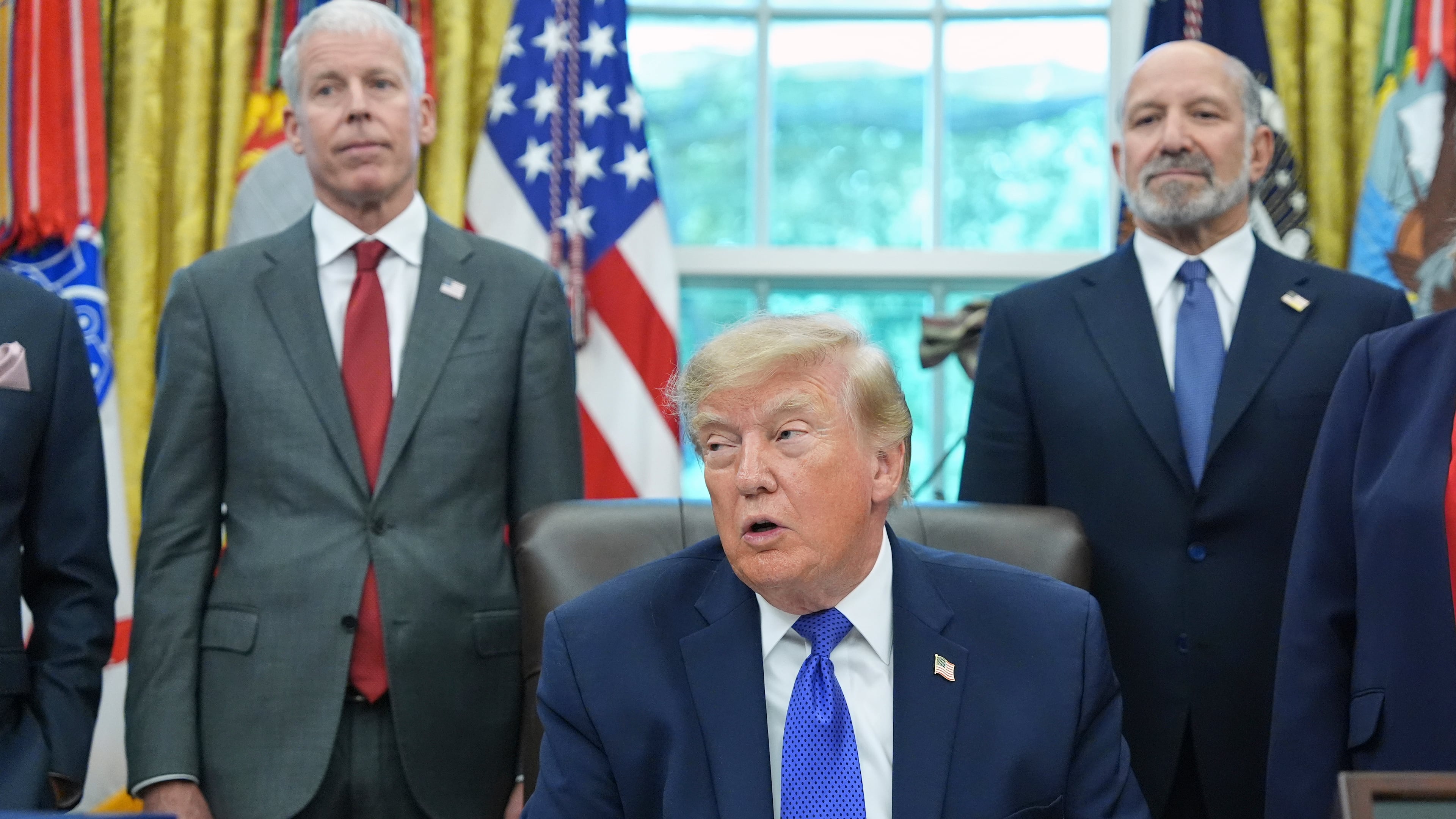 President Donald Trump speaks as Commerce Secretary Howard Lutnick, right, and Energy Secretary Chris Wright listen in the Oval Office of the White House, Monday, Sept. 28, 2026, in Washington. (AP Photo/Alex Brandon)