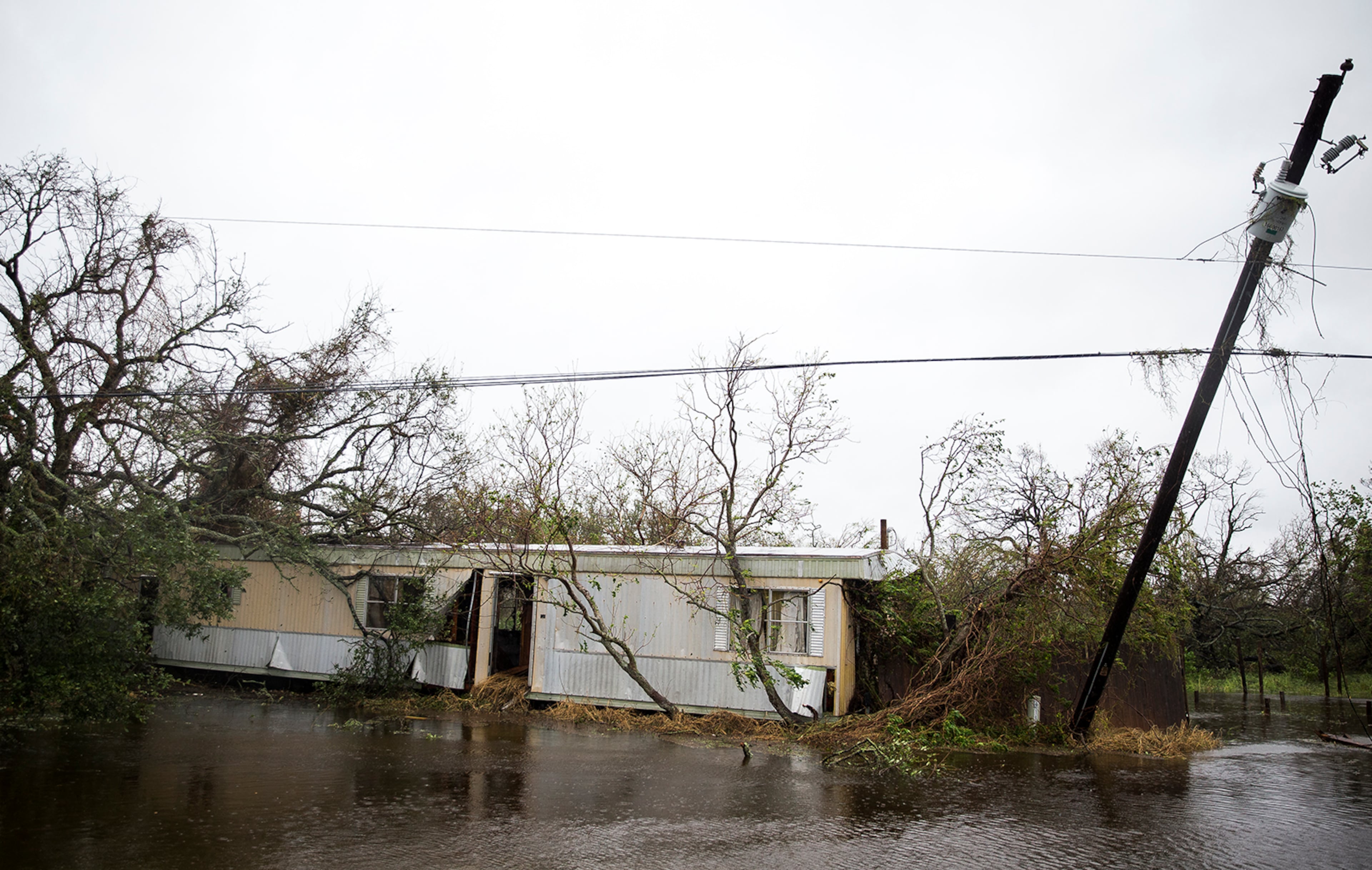 A trailer home sits lodged in trees after Hurricane Harvey ripped through Rockport, Texas, on Saturday, August 26, 2017. The hurricane hit the Texas coast as a category 4 storm, damaging buildings and leaving tens of thousands without power. NICK WAGNER / AMERICAN-STATESMAN