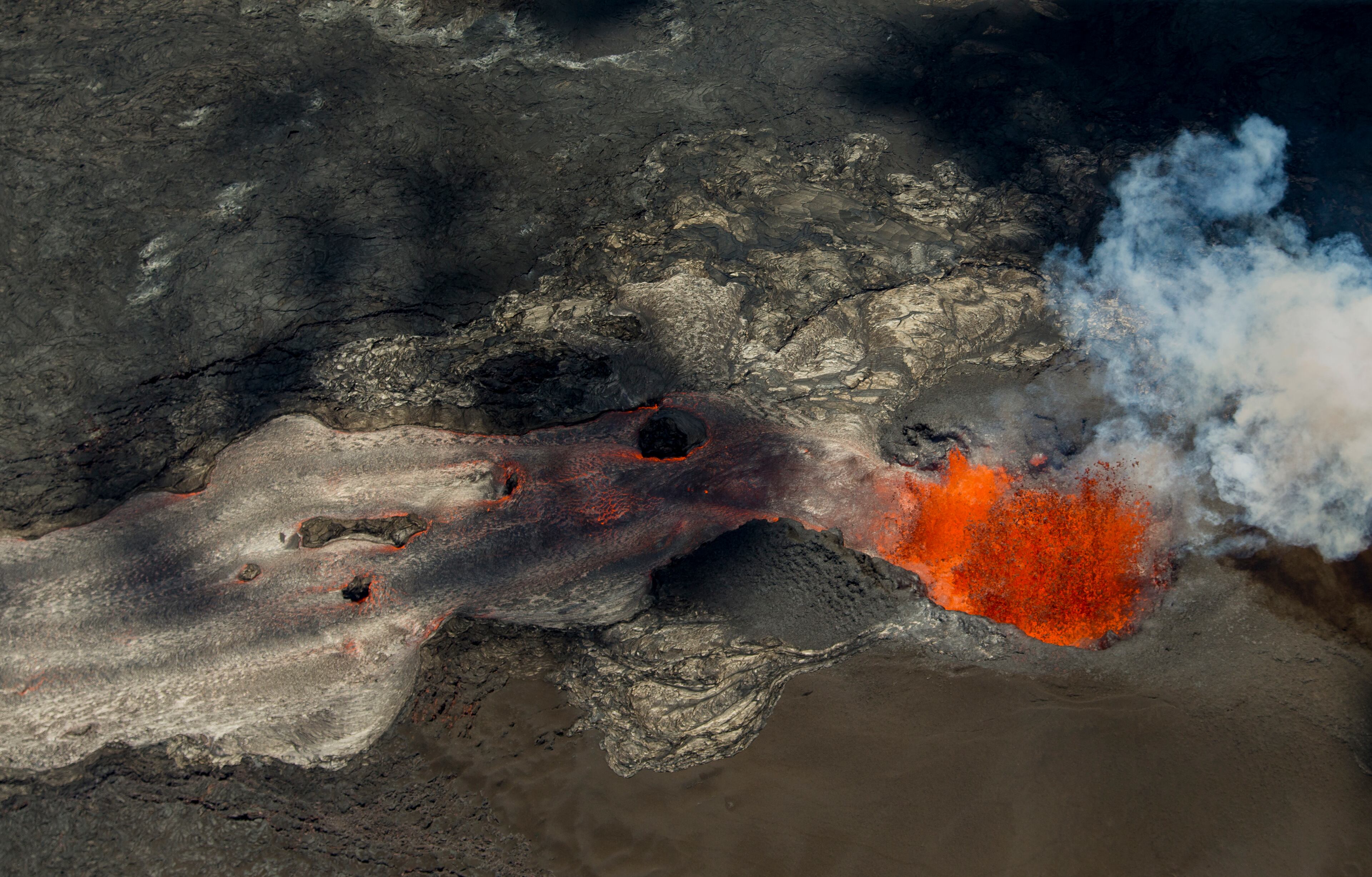 A fissure continues to blast fresh lava several hundred feet in the air and flow towards Kapoho as the Kilauea Volcano lower east rift zone eruption continues on Wednesday, June 6, 2018, in Pahoa, Hawaii. (AP Photo/LE Baskow)