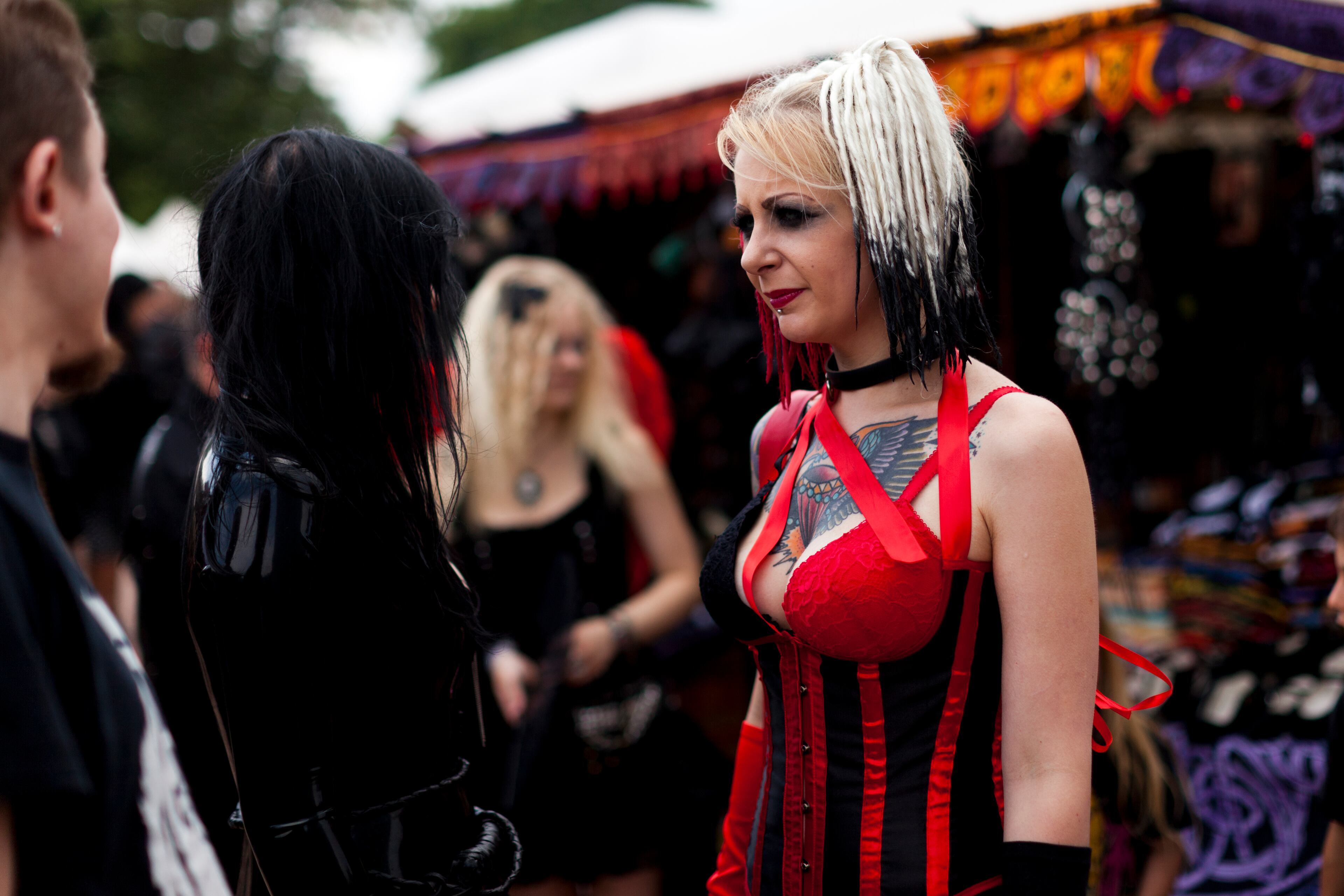 LEIPZIG, GERMANY - JUNE 11: A costumed woman stands on the street between venues during the annual Wave Gotik music festival on June 11, 2011 in Leipzig, Germany. The festival began in the 1990s and has since grown into one of the biggest gatherings of Goth scene followers in Europe with around 20,000 participants. Many of those attending wear elaborate outfits and make-up for which they require hours of painstaking preparation and that also show a departure from the traditional black of the Goth scene. Punk remains a strong influence in todays Goth style as witnessed in Leipzig, but newer trends, with names like Cybergoth and Steampunk, have emerged that blend bold colors, Victorian fashion elegance and 19th and 20th century factory accessories into a look reminiscent of a mutated Venetian carnival. The five-day festival includes performances by around 200 bands. (Photo by Carsten Koall/Getty Images)