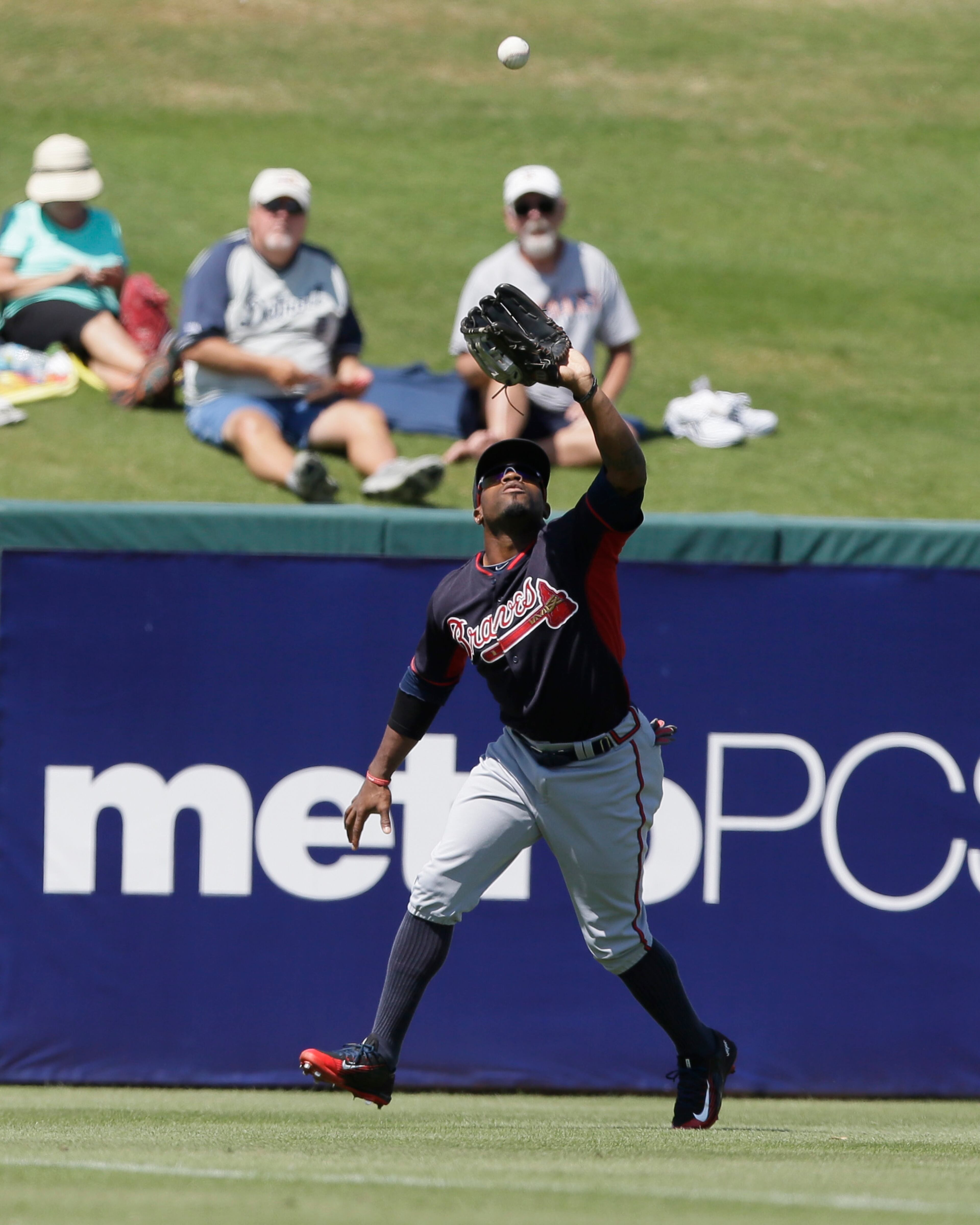 Atlanta Braves left fielder Eric Young Jr. makes a catch during a spring training exhibition baseball game against the Detroit Tigers in Lakeland, Fla., Monday, March 30, 2015. (AP Photo/Carlos Osorio)