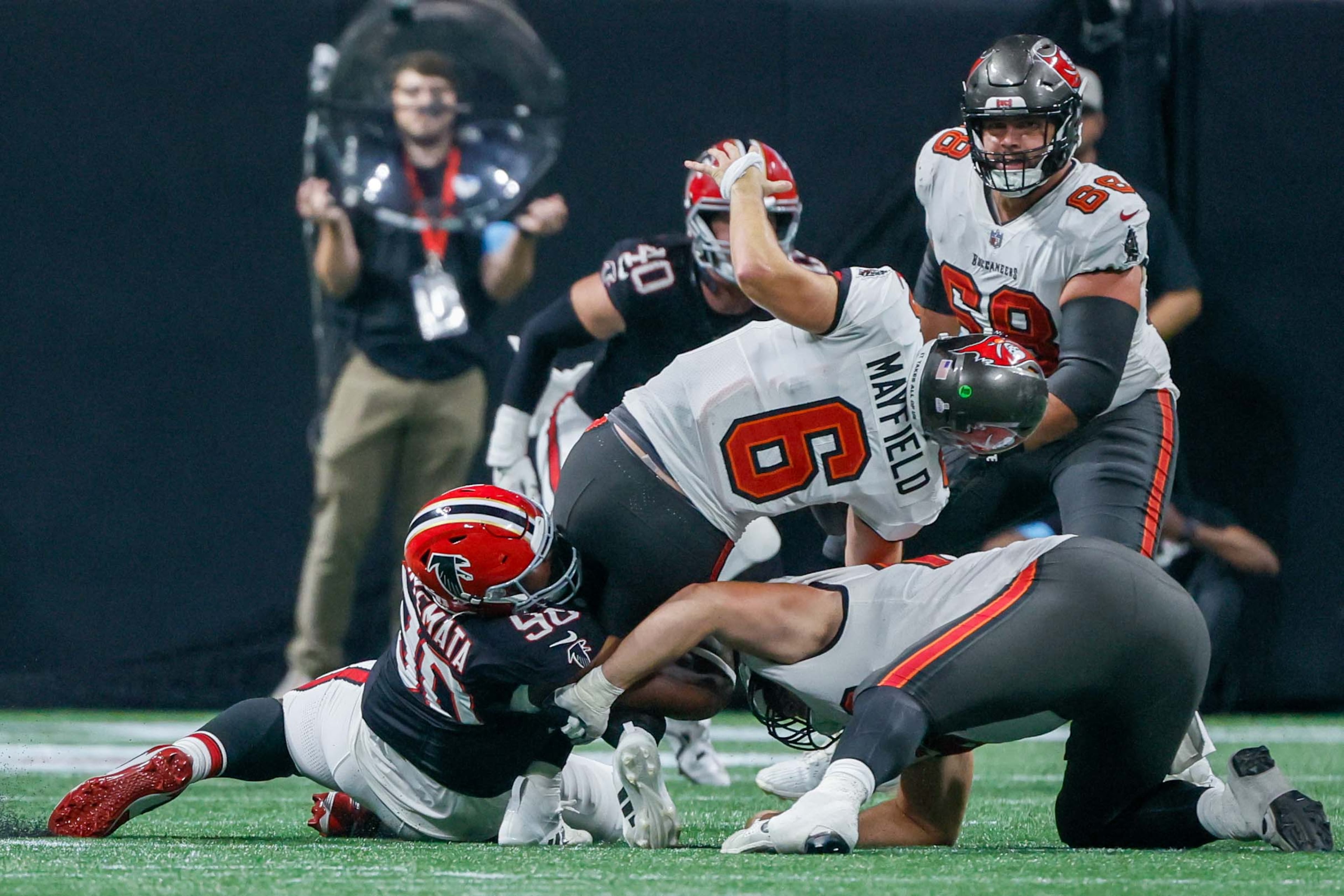 Atlanta Falcons defensive tackle David Onyemata (90) sacks Tampa Bay Buccaneers quarterback Baker Mayfield (6) during the second half of an NFL football game on Thursday, October 3, 2024, at Mercedes-Benz Stadium in Atlanta.
(Miguel Martinez/ AJC)