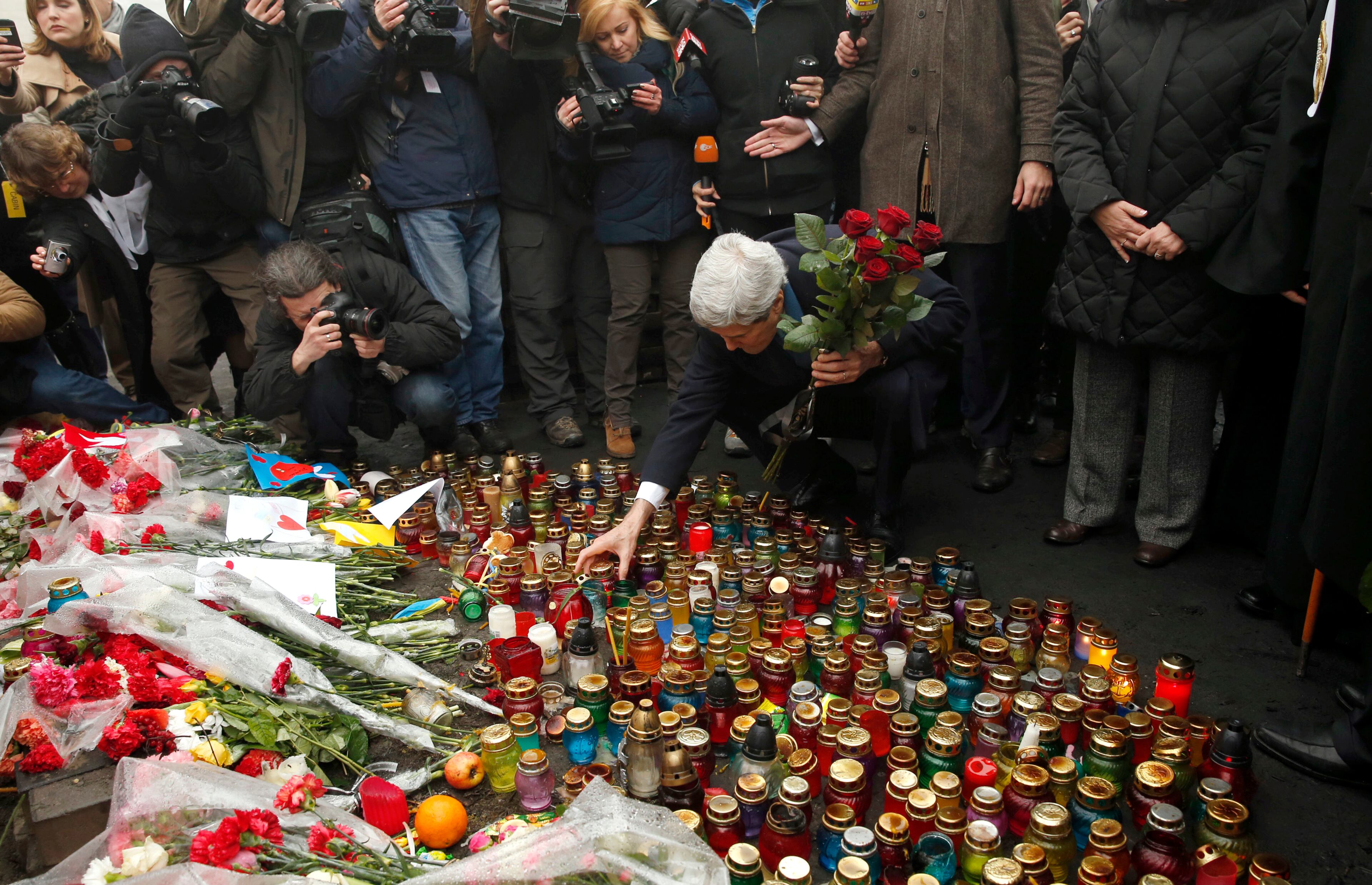 Secretary of State John Kerry places roses atop the Shrine of the Fallen in Kiev, Ukraine March 4, 2014. The Shrine of the Fallen, located on Institutska Street, honors the fallen Heroes of the "Heavenly Sotnya" (Hundred). Over the course of the EuroMaidan protests, almost 100 protesters were killed by police. (AP PHoto/Kevin Lamarque, Pool)