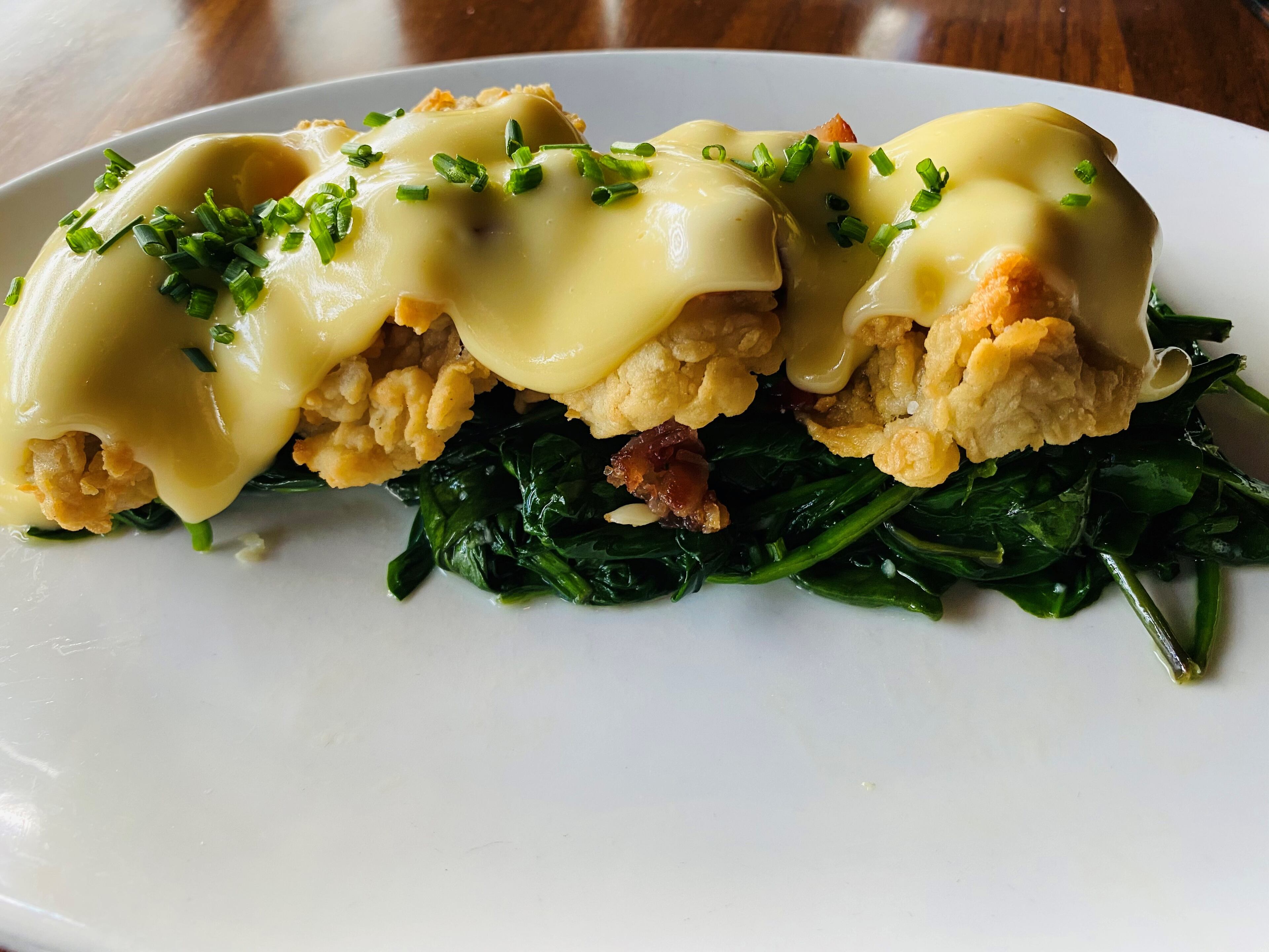 Fried Gulf oysters Rockefeller, with spinach, bacon and hollandaise sauce, are available at Kaiser’s Chophouse. Bob Townsend for The Atlanta Journal-Constitution