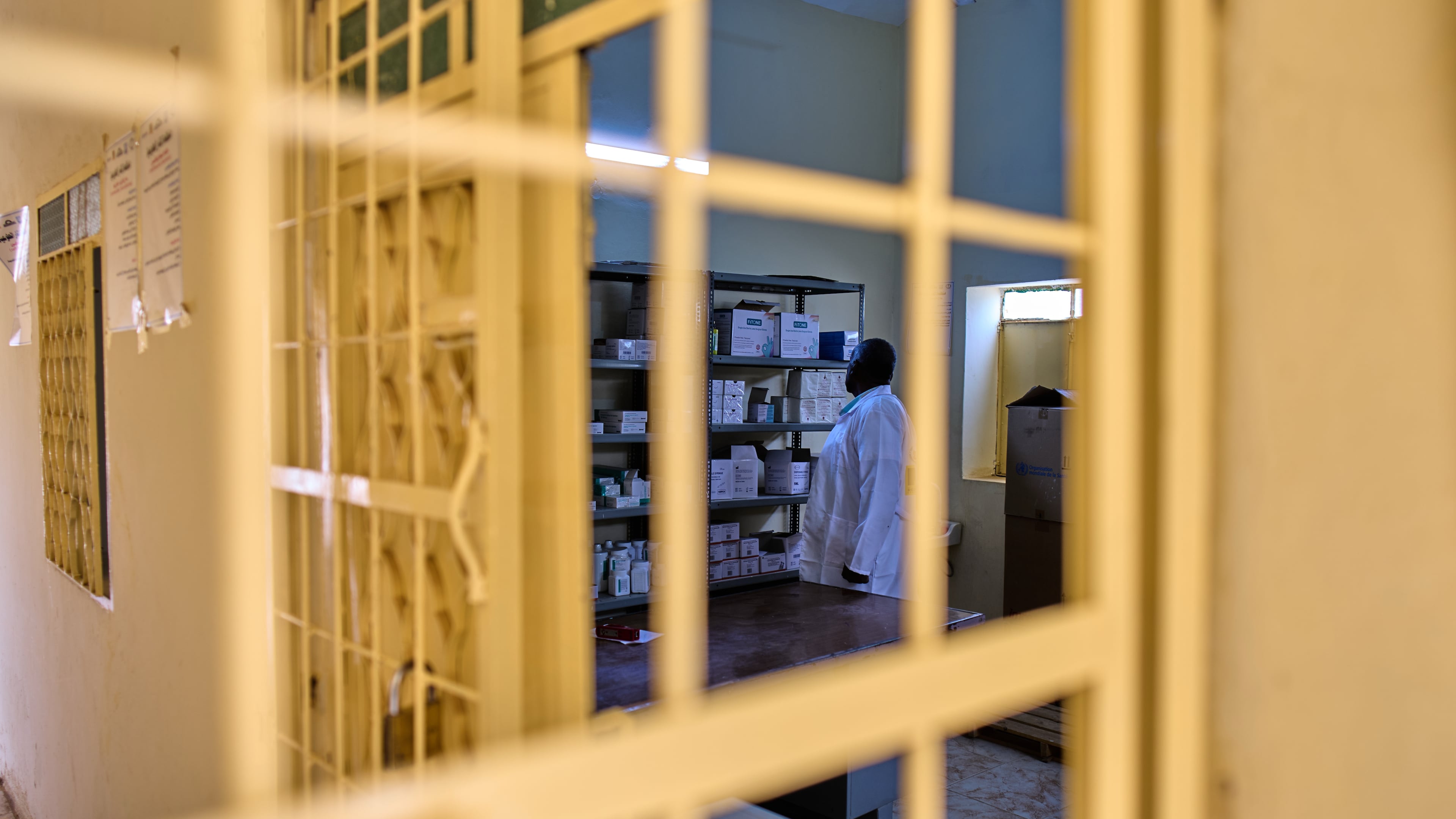 A staffer checks the pharmacy shelves at a public health clinic in Qoz Nafisa village, Khartoum state, Sudan, Wednesday, April 22, 2026. (AP Photo/Bernat Armangue)