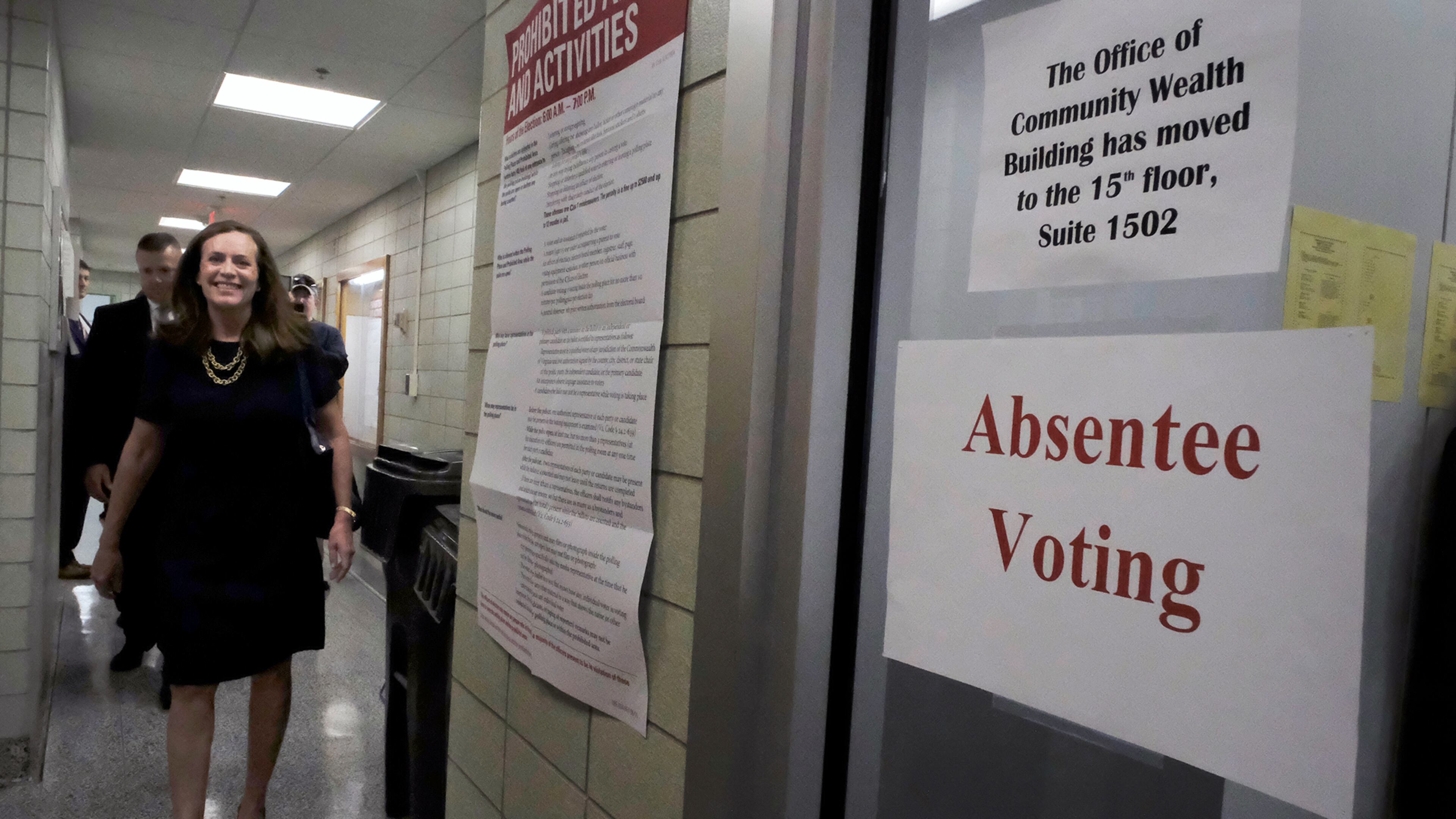 Virginia first lady Dorothy McAuliffe heads to cast an absentee ballot inside City Hall in Richmond, Va., on Tuesday. She said she would be out of town on Nov. 8, Election Day. Bob Brown/Richmond Times-Dispatch via AP