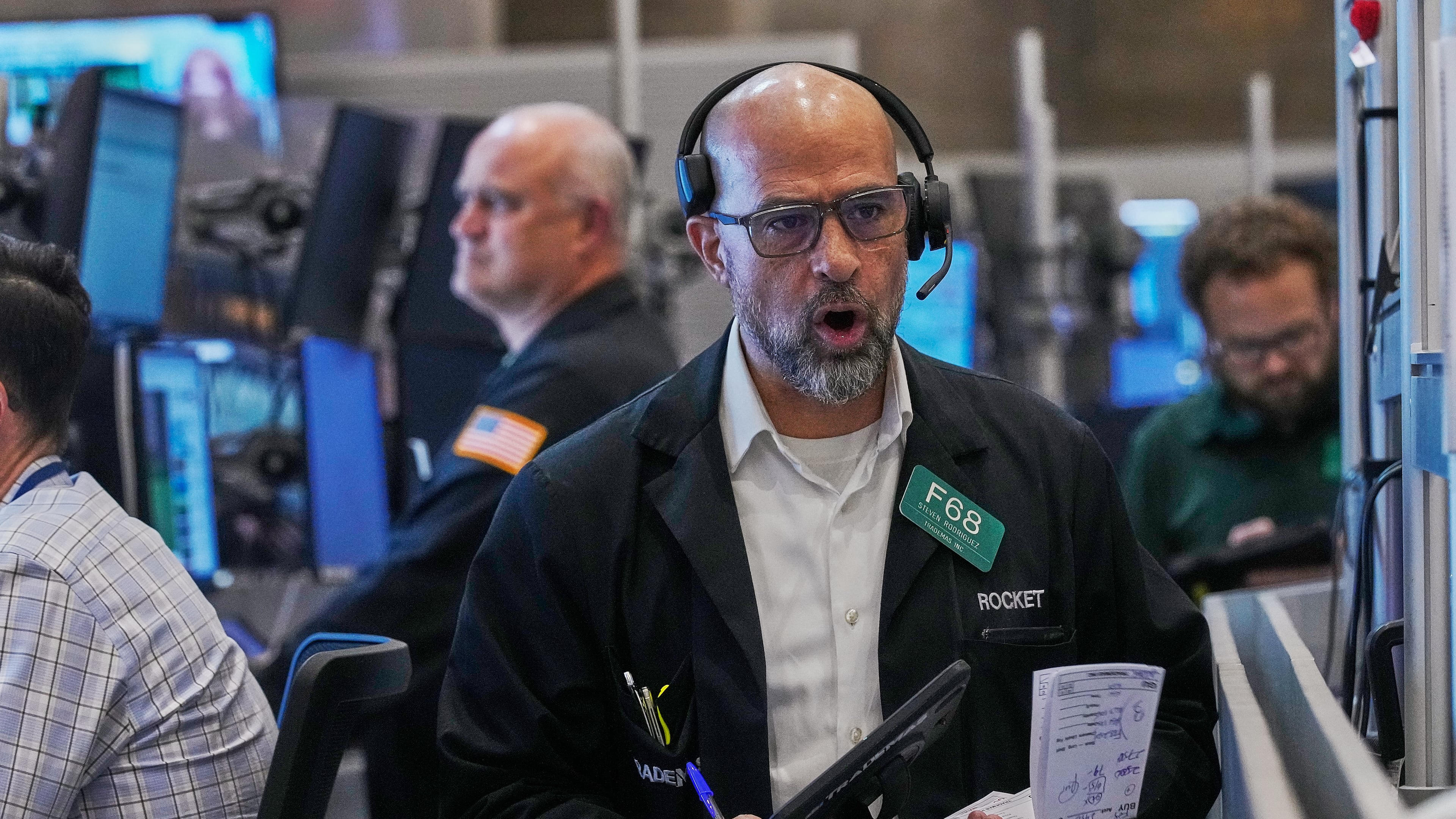 Options trader Steven Rodriguez, center, works on the floor of the New York Stock Exchange, Friday, May 29, 2026. (AP Photo/Richard Drew)