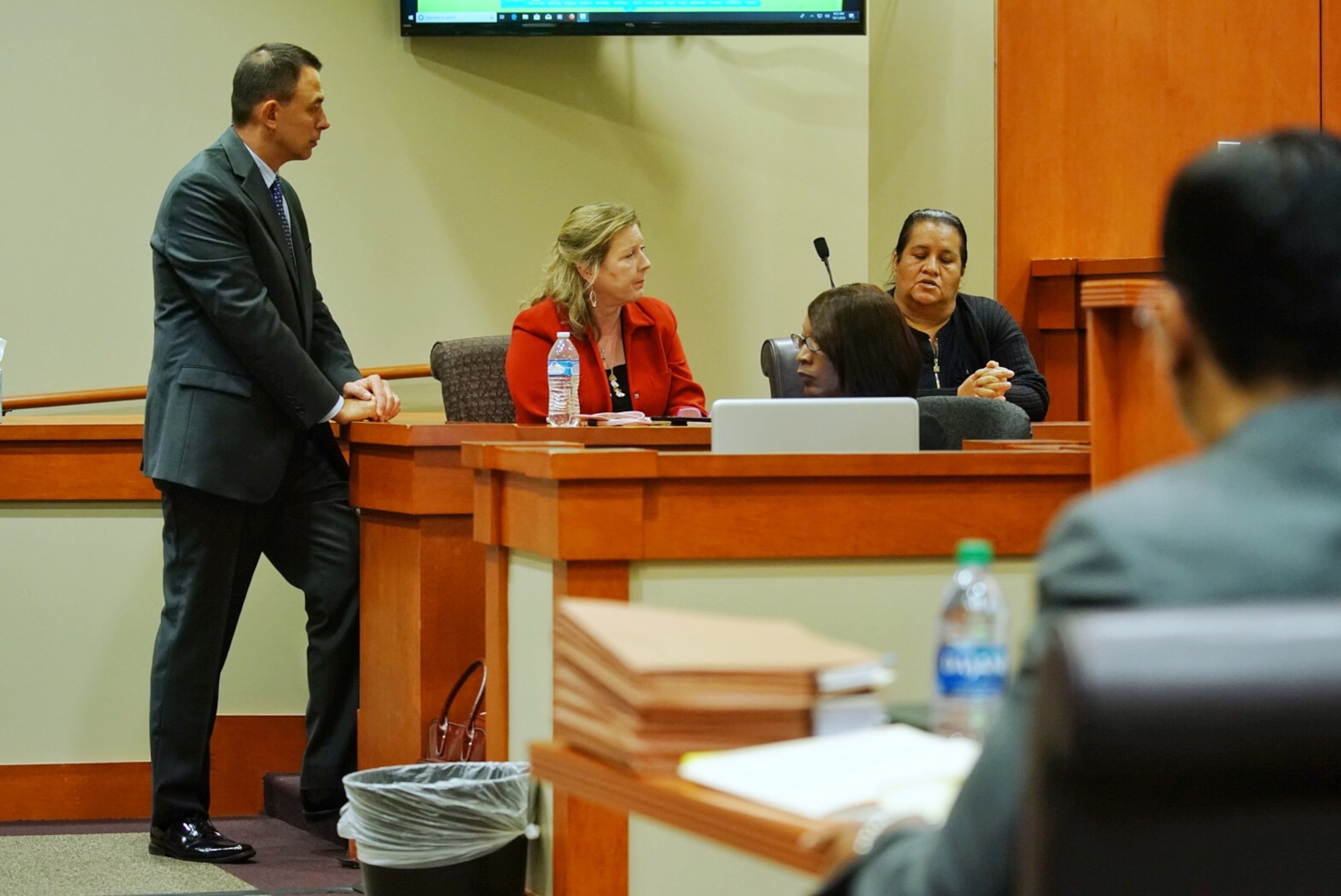 Witness Araceli Vega, right, looks at a photo of her apartment from the location of the shooting while on the witness stand during day three of the Robert Olson murder trial at the DeKalb County Courthouse on October 1, 2019 in Decatur. (Elijah Nouvelage for The Atlanta Journal Constitution)