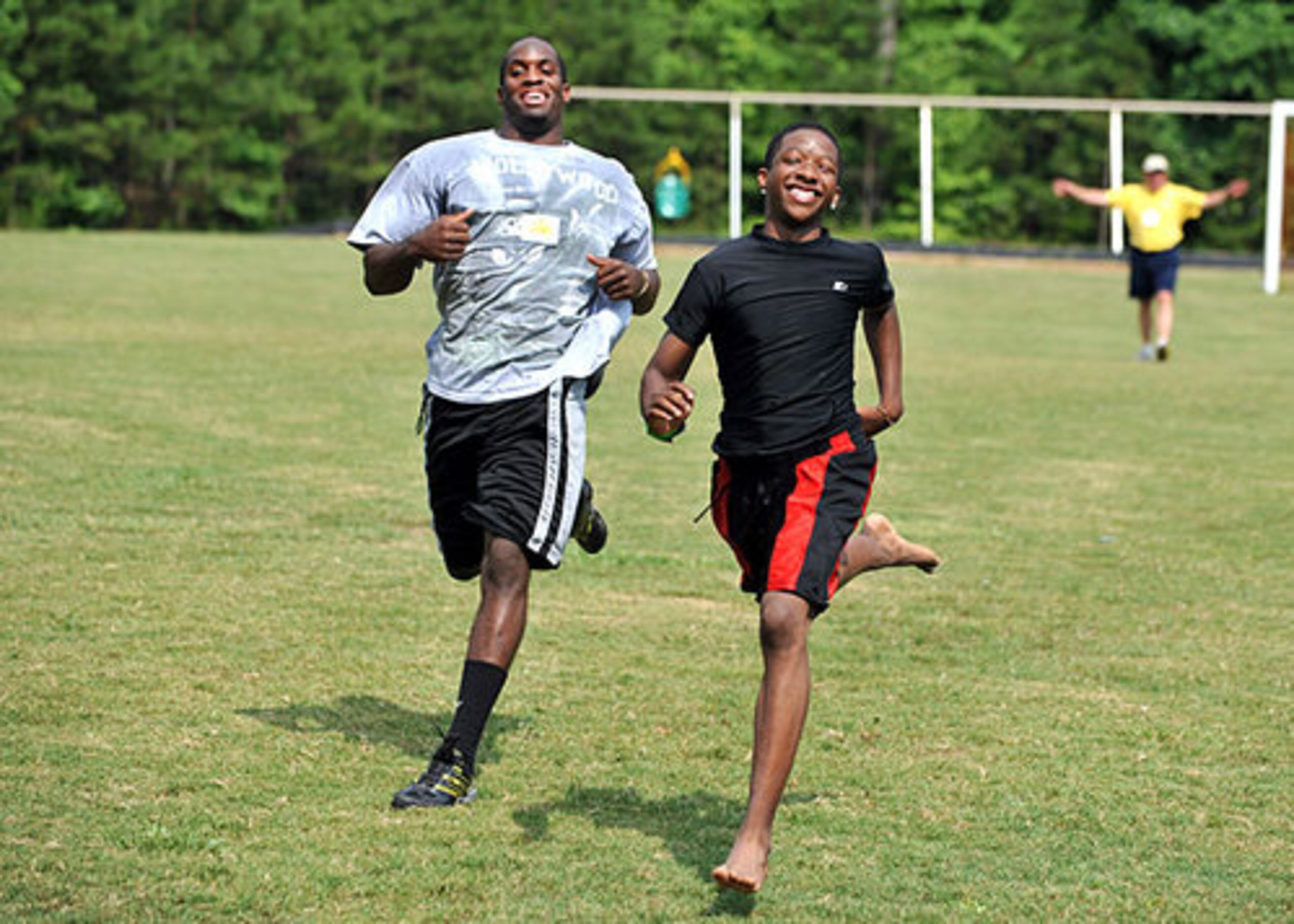 Cancer survivor Crayton Petterson, 16, from Stone Mountain races UGA running back Richard Samuel at Camp Sunshine. Petterson, who was racing barefoot beat Samuel who was running in borrowed shoes. Select members of the UGA football team visited Camp Sunshine in Rutledge Wednesday. Camp Sunshine is dedicated to kids who have or had cancer.
