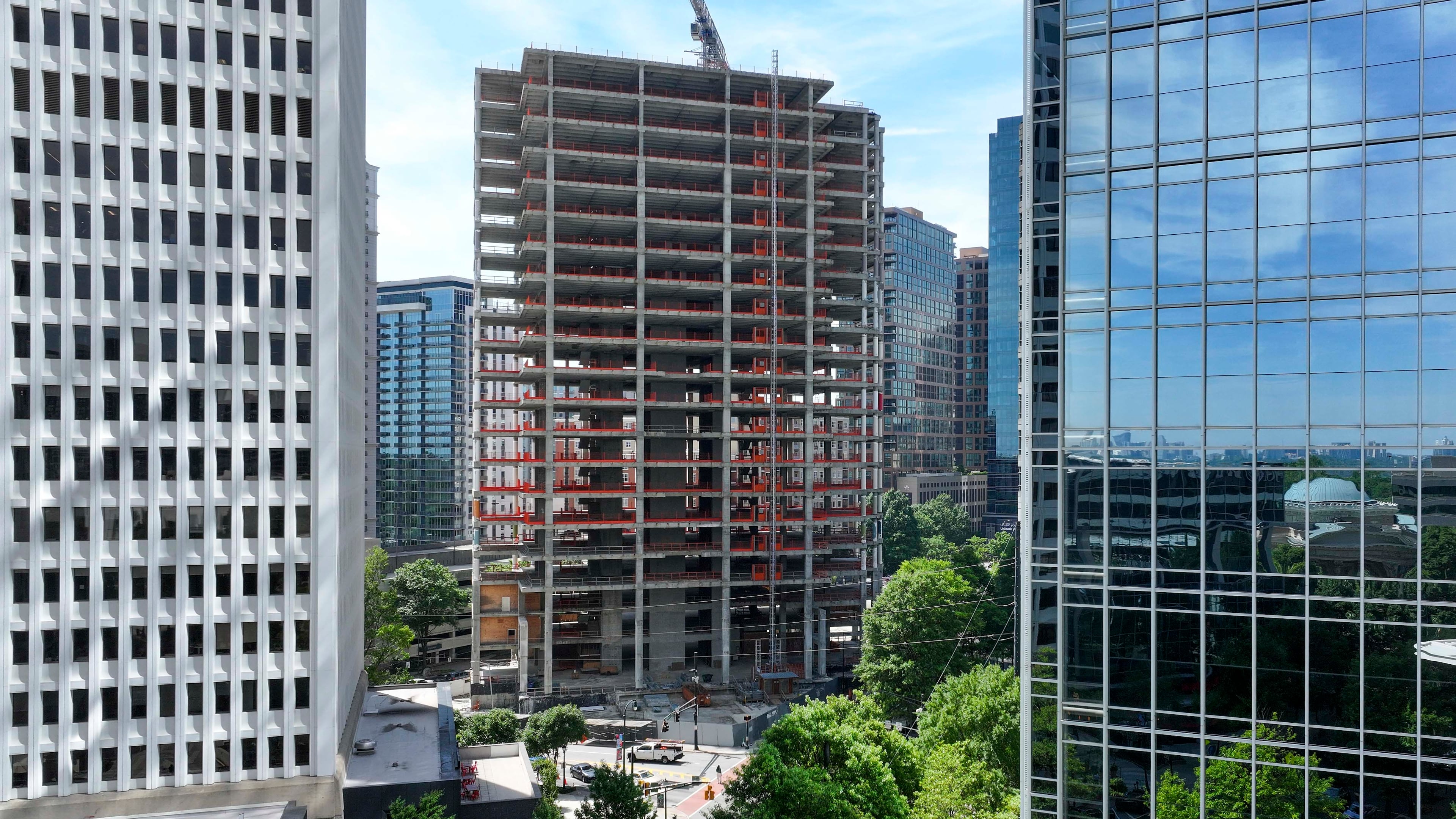 An aerial photo from May 2026 shows the Campanile building at the corner of Peachtree and 14th Streets in Midtown Atlanta . The well-known construction site, which its owner has renamed The Midtowne, has remained unfinished for years. (Miguel Martinez/AJC)