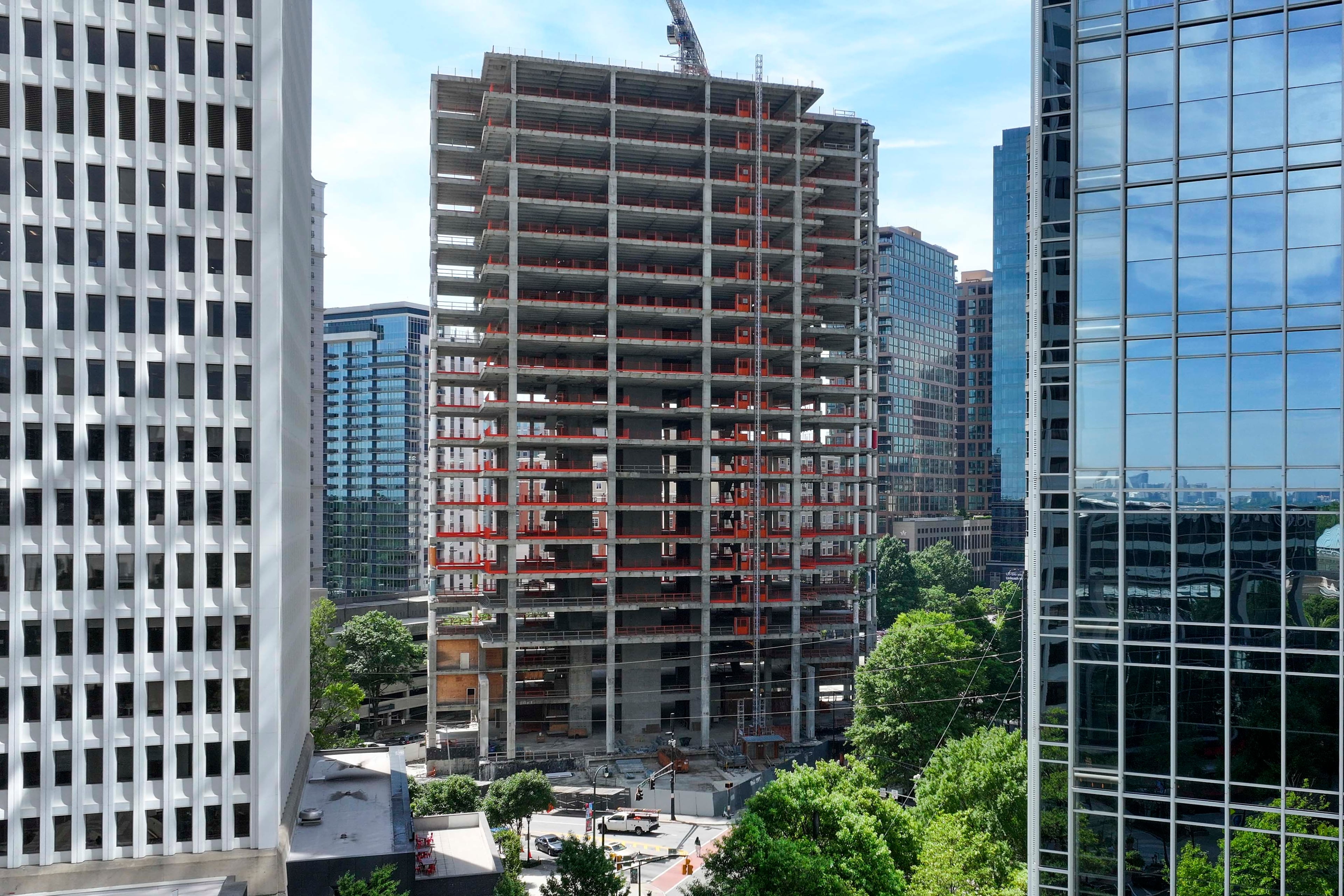 An aerial photo from May 2026 shows the Campanile building at the corner of Peachtree and 14th Streets in Midtown Atlanta . The well-known construction site, which its owner has renamed The Midtowne, has remained unfinished for years. (Miguel Martinez/AJC)