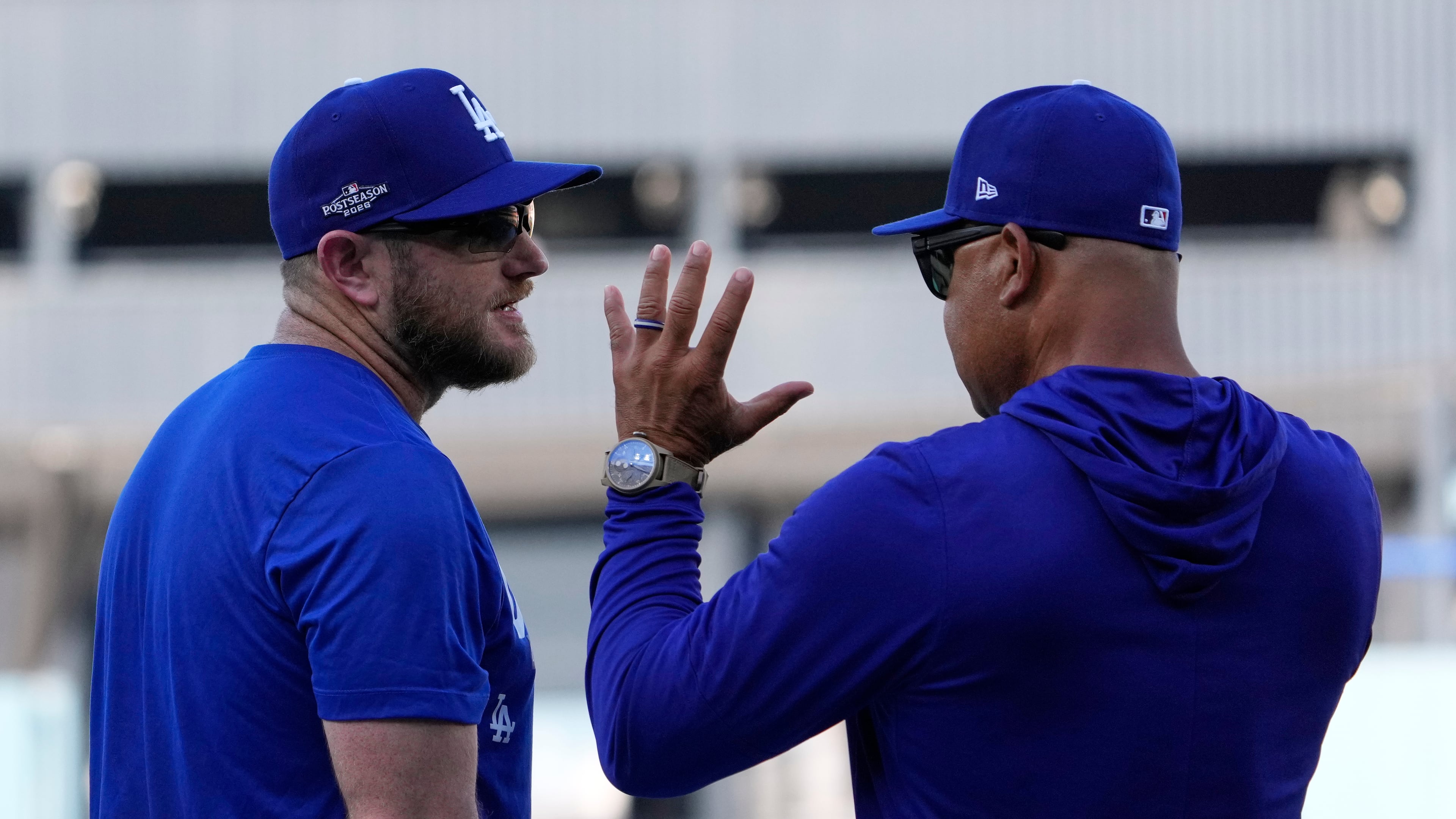 Los Angeles Dodgers third baseman Max Muncy, left, talks with manager Dave Roberts during practice ahead of a baseball NL Division Series Thursday, Oct. 1, 2026, in Los Angeles. (AP Photo/Mark J. Terrill)