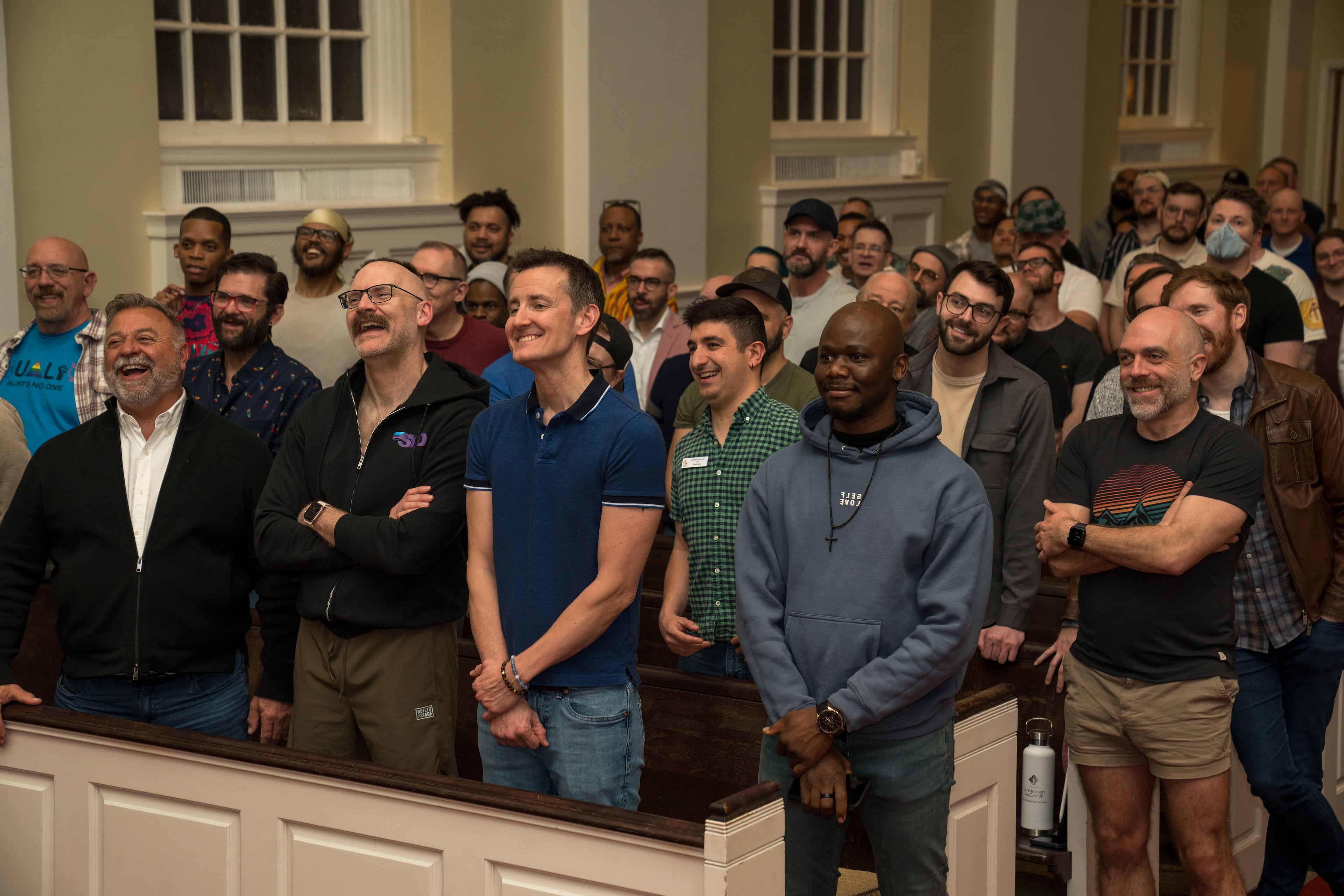 The Atlanta Gay Men's Chorus enjoying a light moment in rehearsal with the Atlanta Women's Chorus for the shared 2025 "This Is Me!" concert at Glenn Memorial United Methodist Church. (Photo courtesy of Voices of Note/Dan Lax)