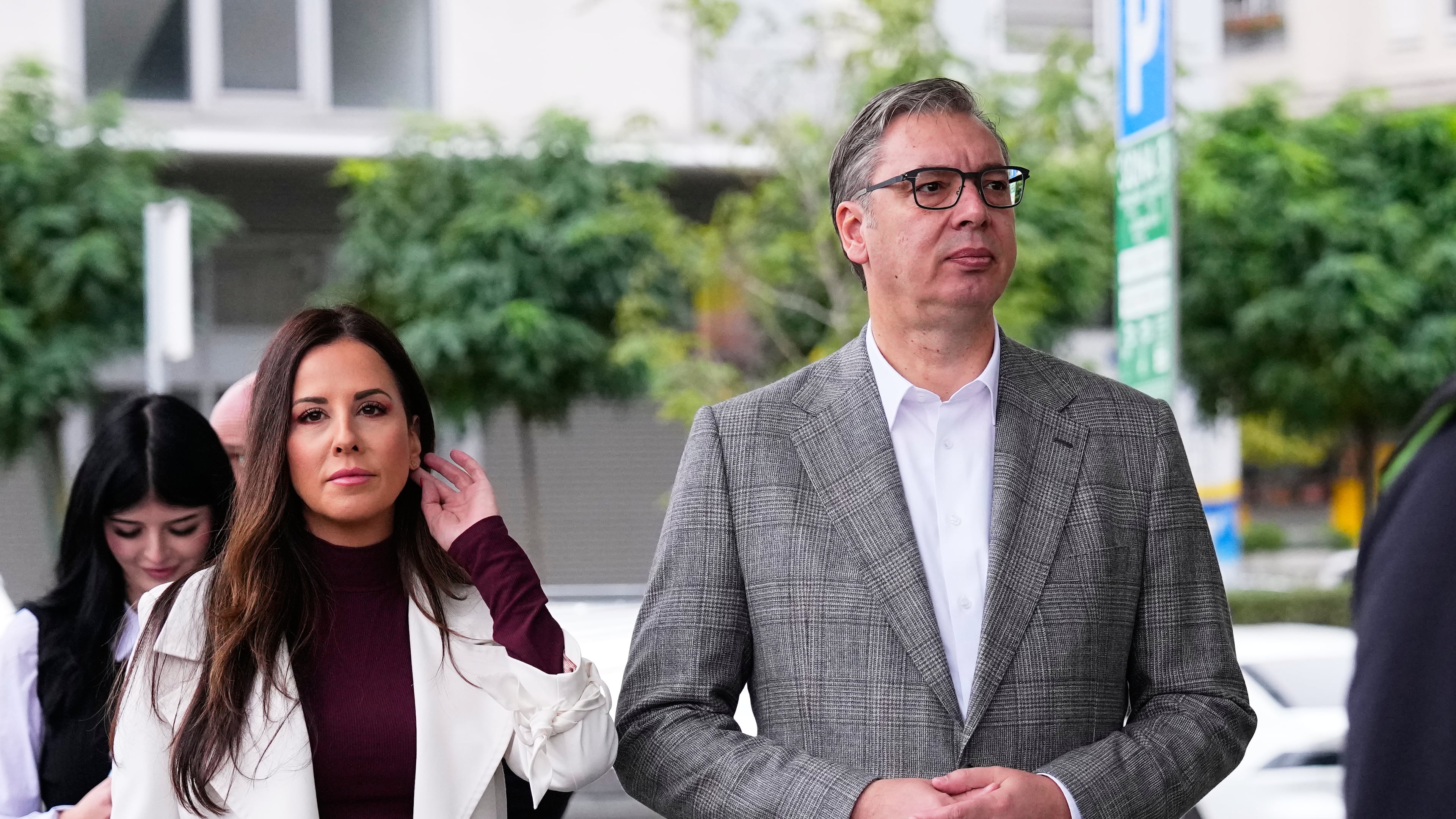 Aleksandar Vucic, leader of the right-wing Serbian Progressive Party (SNS), waits along with his wife Tamara to vote in a parliamentary election in Belgrade, Serbia, Sunday, Oct. 25, 2026. (AP Photo/Petr David Josek)