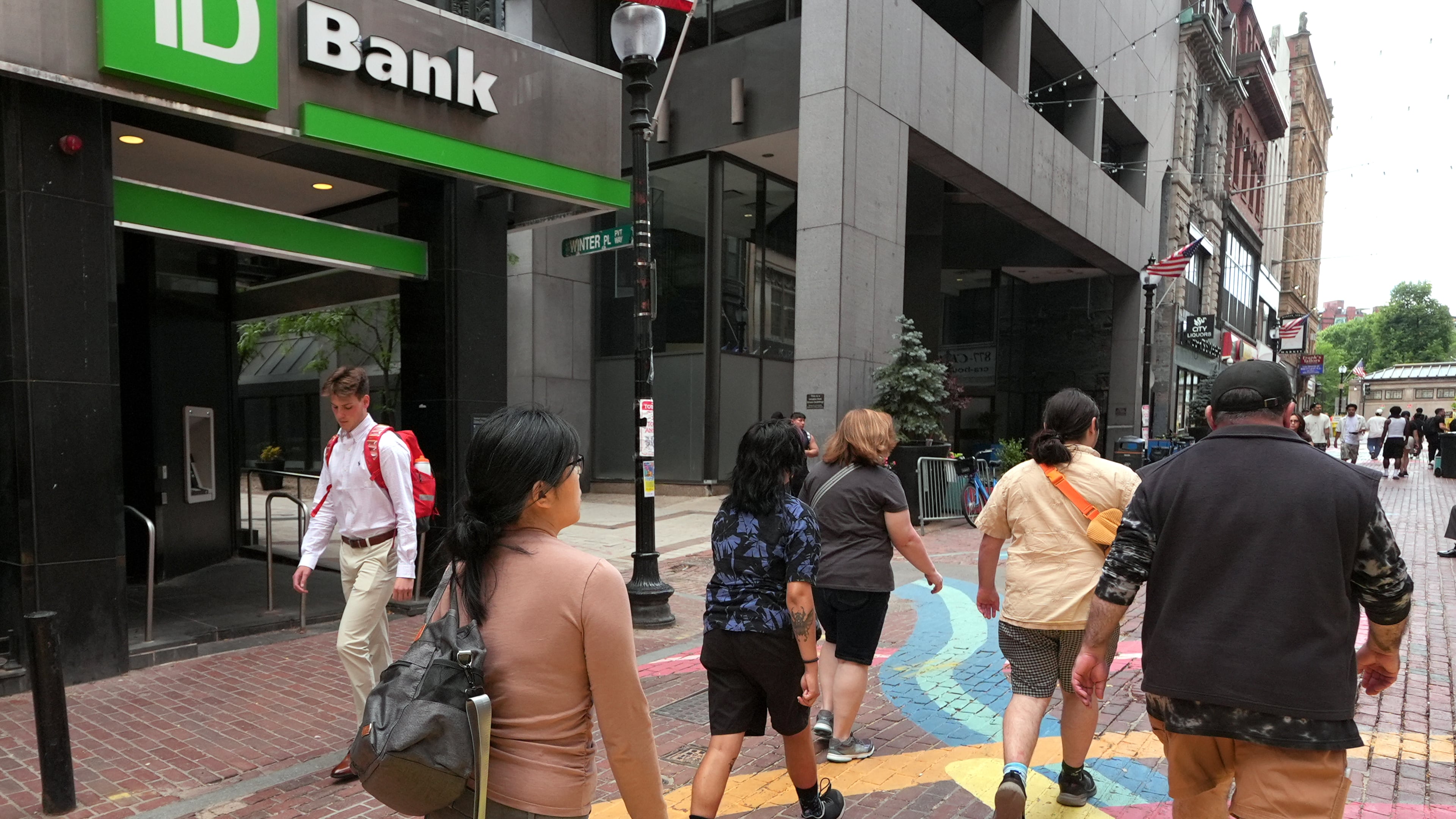 FILE - Pedestrians pass a TD Bank location, June 24, 2026, in Boston. (AP Photo/Charles Krupa, File)